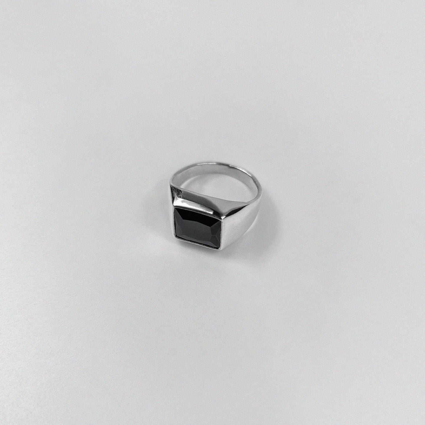 Sterling silver ring stamped '925,' featuring a bold black stone centerpiece.