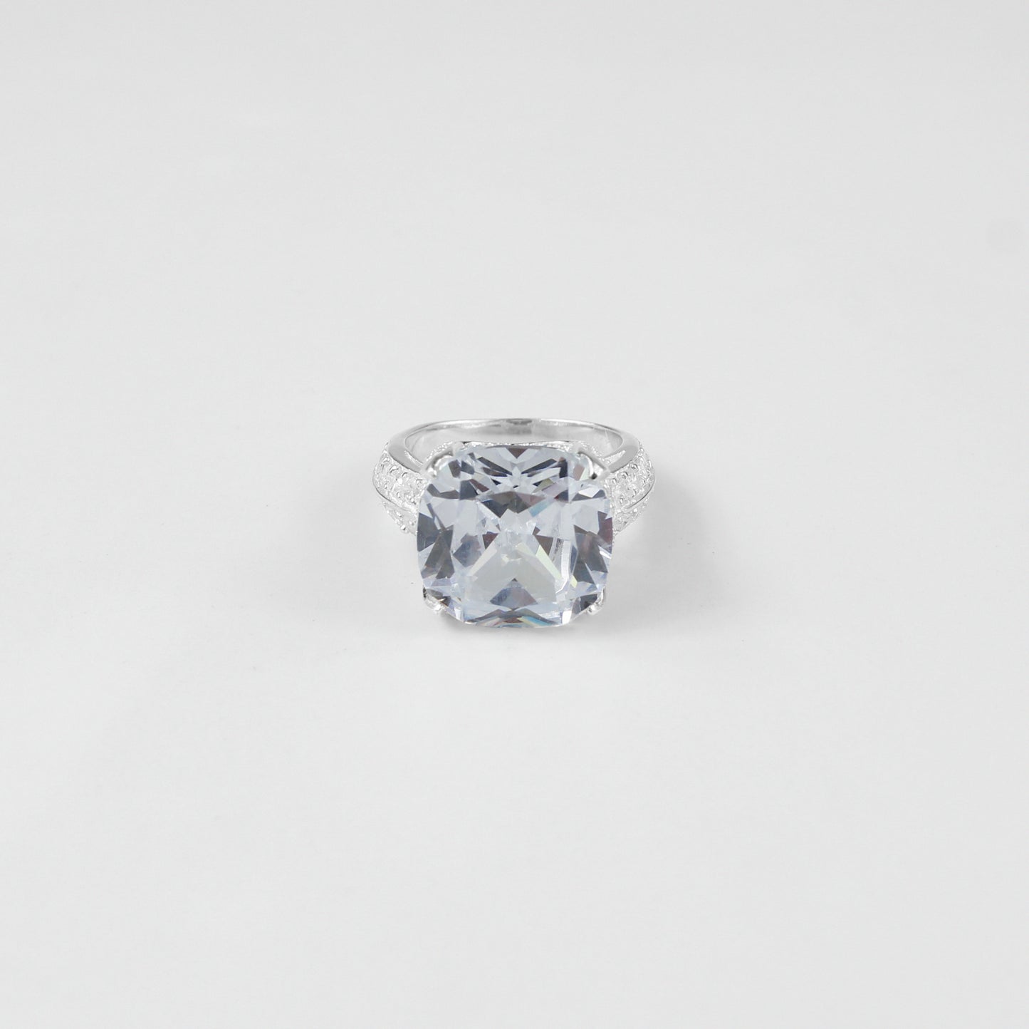 925 sterling silver ring named 'Cushion Cut Splendor,' featuring a dazzling cushion-cut centerpiece that radiates elegance and brilliance. Its exquisite design highlights a perfect blend of sophistication and charm, ideal for making a bold yet refined statement.