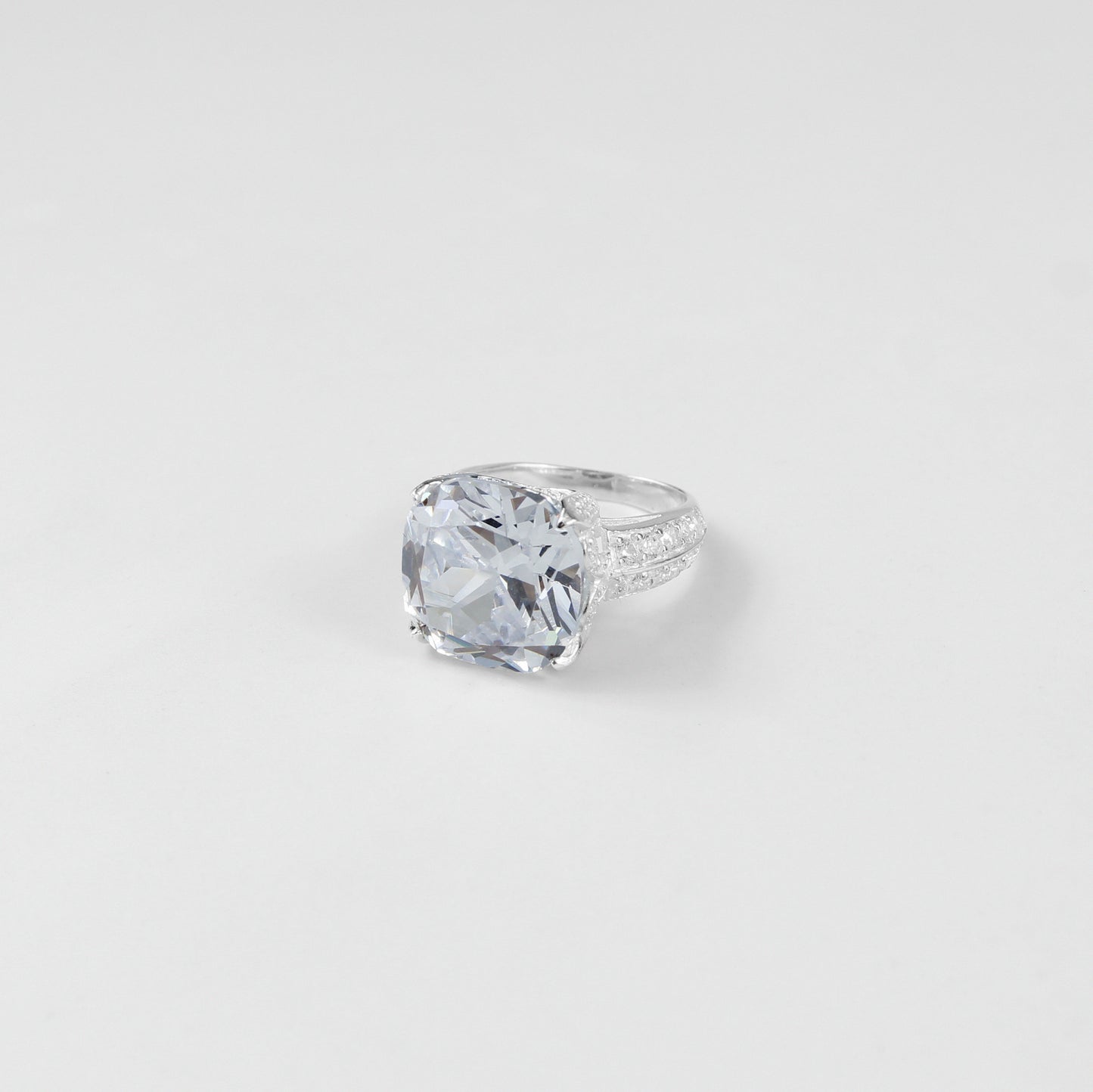925 sterling silver ring named 'Cushion Cut Splendor,' featuring a dazzling cushion-cut centerpiece that radiates elegance and brilliance. Its exquisite design highlights a perfect blend of sophistication and charm, ideal for making a bold yet refined statement.