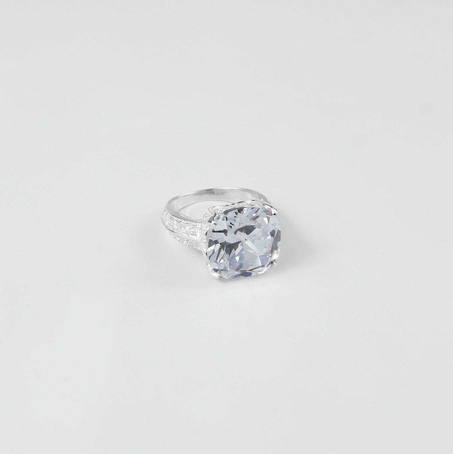 925 sterling silver ring named 'Cushion Cut Splendor,' featuring a dazzling cushion-cut centerpiece that radiates elegance and brilliance. Its exquisite design highlights a perfect blend of sophistication and charm, ideal for making a bold yet refined statement.