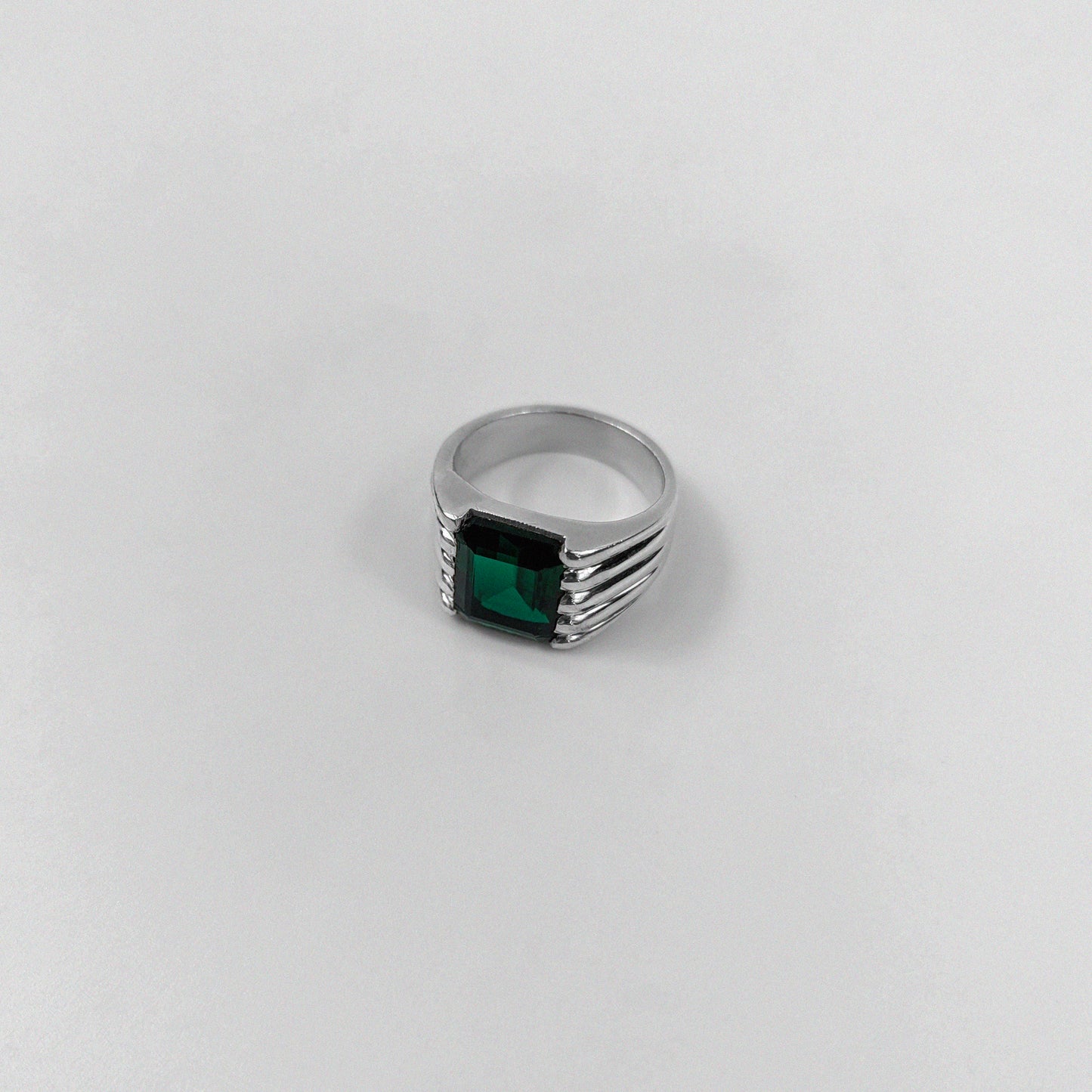 Sterling silver ring stamped '925,' featuring a square emerald gemstone with a radiant shine, named 'Emerald Square Radiance Ring.