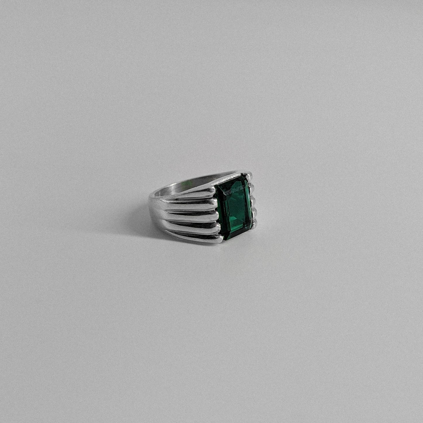 Sterling silver ring stamped '925,' featuring a square emerald gemstone with a radiant shine, named 'Emerald Square Radiance Ring.