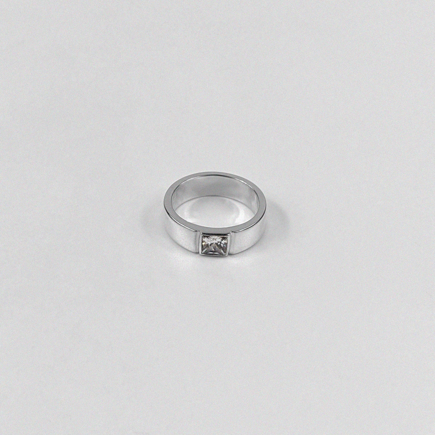 "925 sterling silver ring featuring a sleek design with a white stone centerpiece, named 'Meridian White Stone Ring.'"