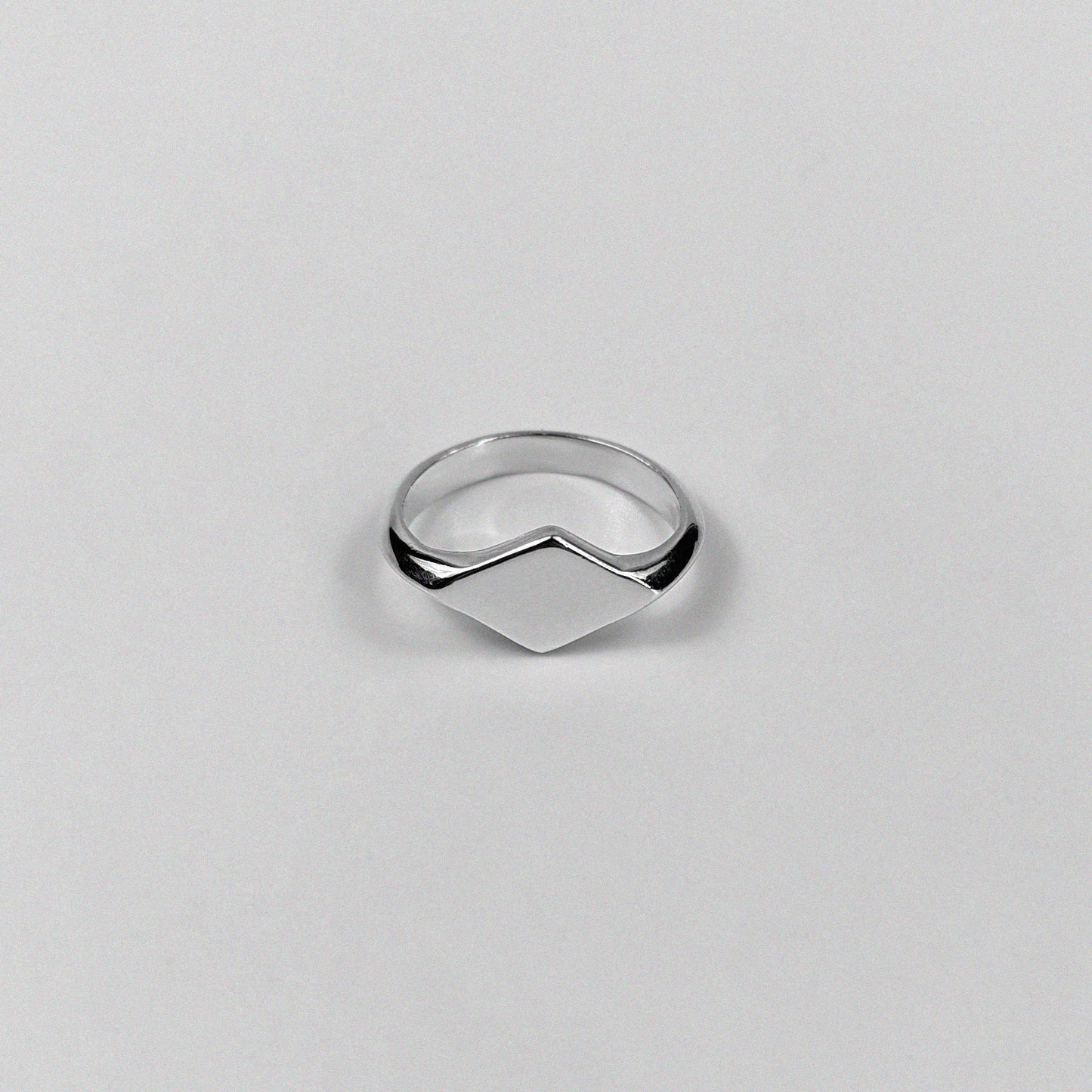 "925 sterling silver signet ring featuring a smooth, polished design, named 'Milley Signet Ring.'"