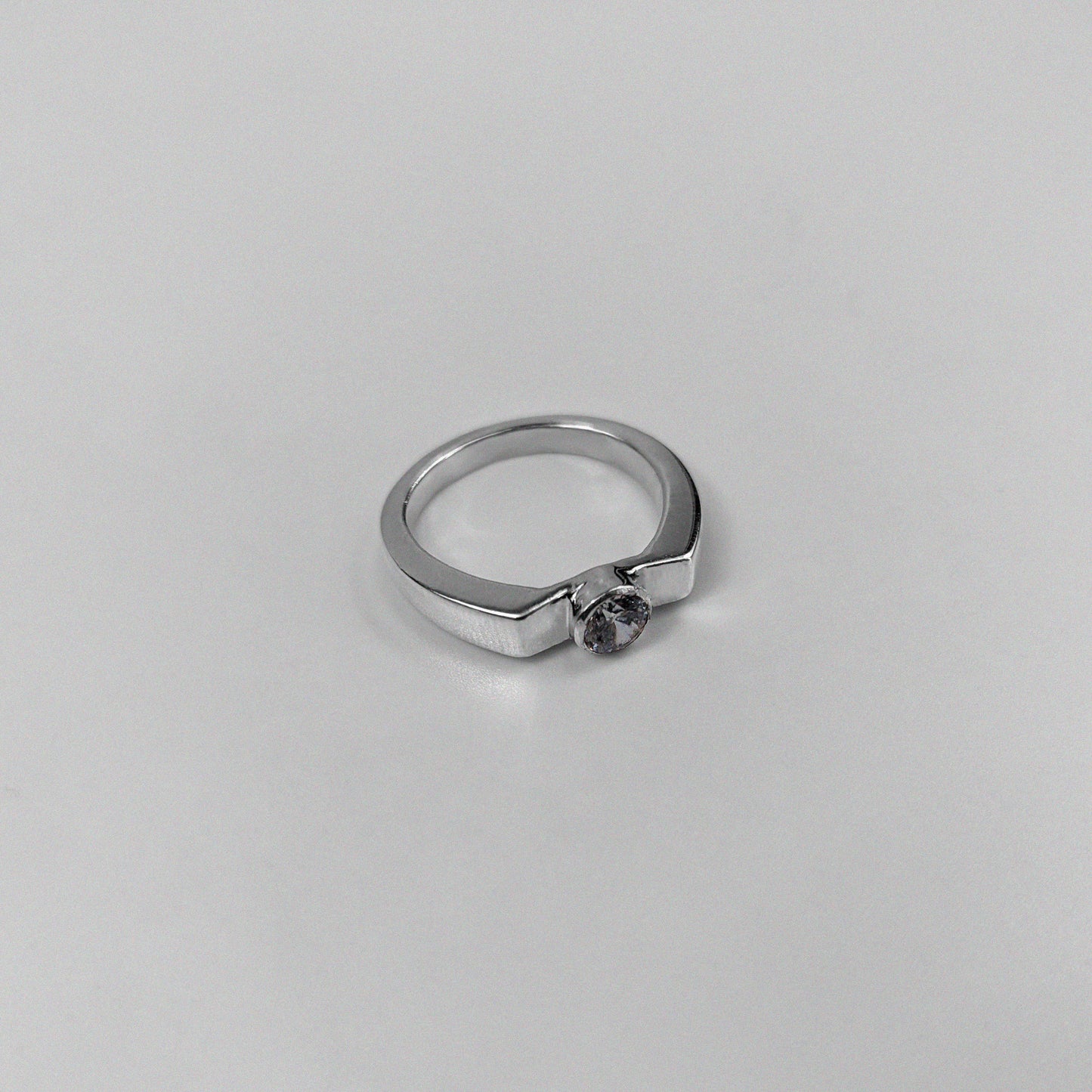 925 sterling silver ring featuring a classic design with a round white stone at its center, named 'White Round Stone Ring.