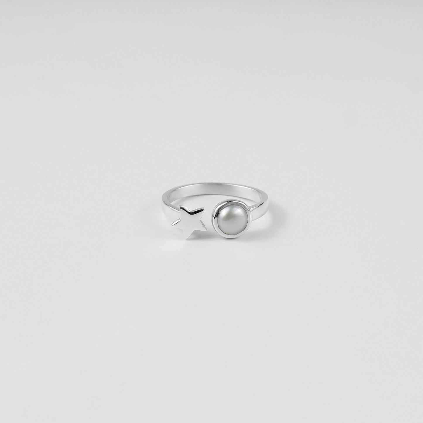 "925 sterling silver ring featuring a star and pearl design, offering a touch of elegance and charm, named 'Star & Pearl Ring.'"
