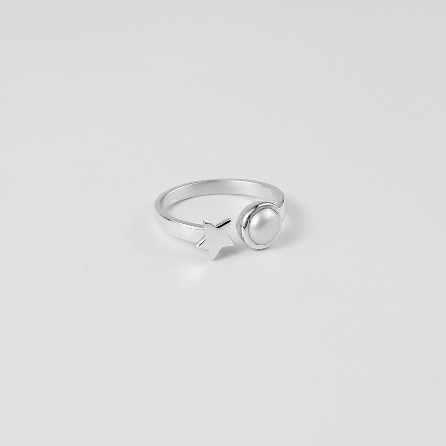 "925 sterling silver ring featuring a star and pearl design, offering a touch of elegance and charm, named 'Star & Pearl Ring.'"