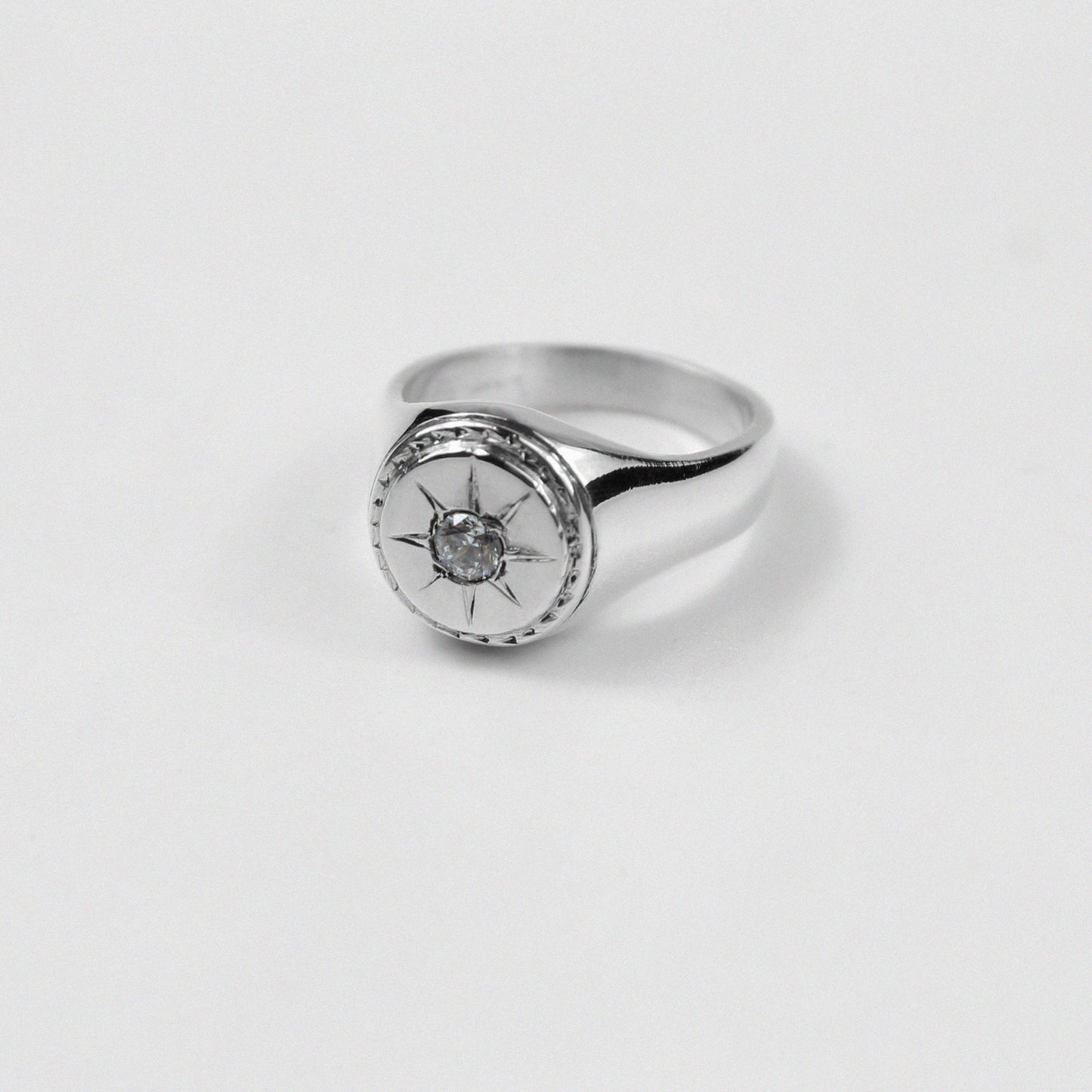"925 sterling silver signet ring with a distinctive star-shaped design, named 'Star Signet Ring.'"