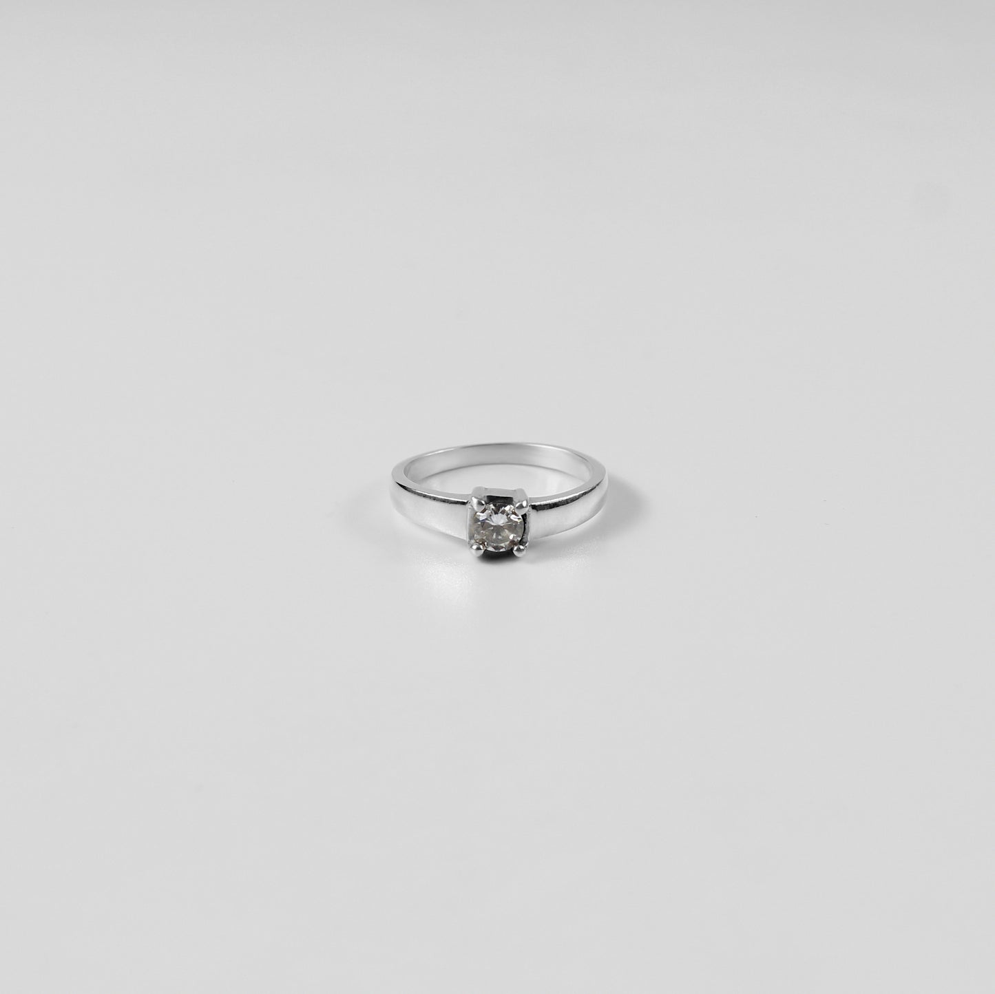 A polished Sterling Grace Band Ring made from 925 sterling silver, exuding refined elegance and subtle charm.