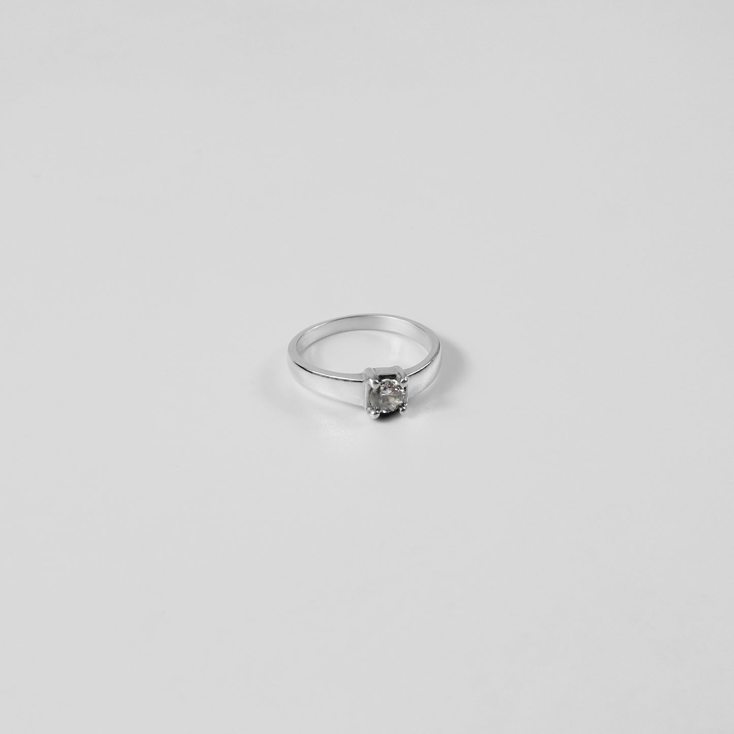 A polished Sterling Grace Band Ring made from 925 sterling silver, exuding refined elegance and subtle charm.