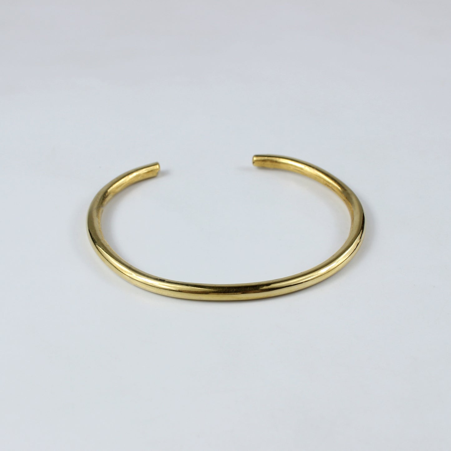 An elegant cuff bracelet made from brass and plated with 18k gold, featuring a sleek and modern design. The Vero Cuff Bracelet radiates contemporary sophistication, making it a versatile accessory for any wardrobe.