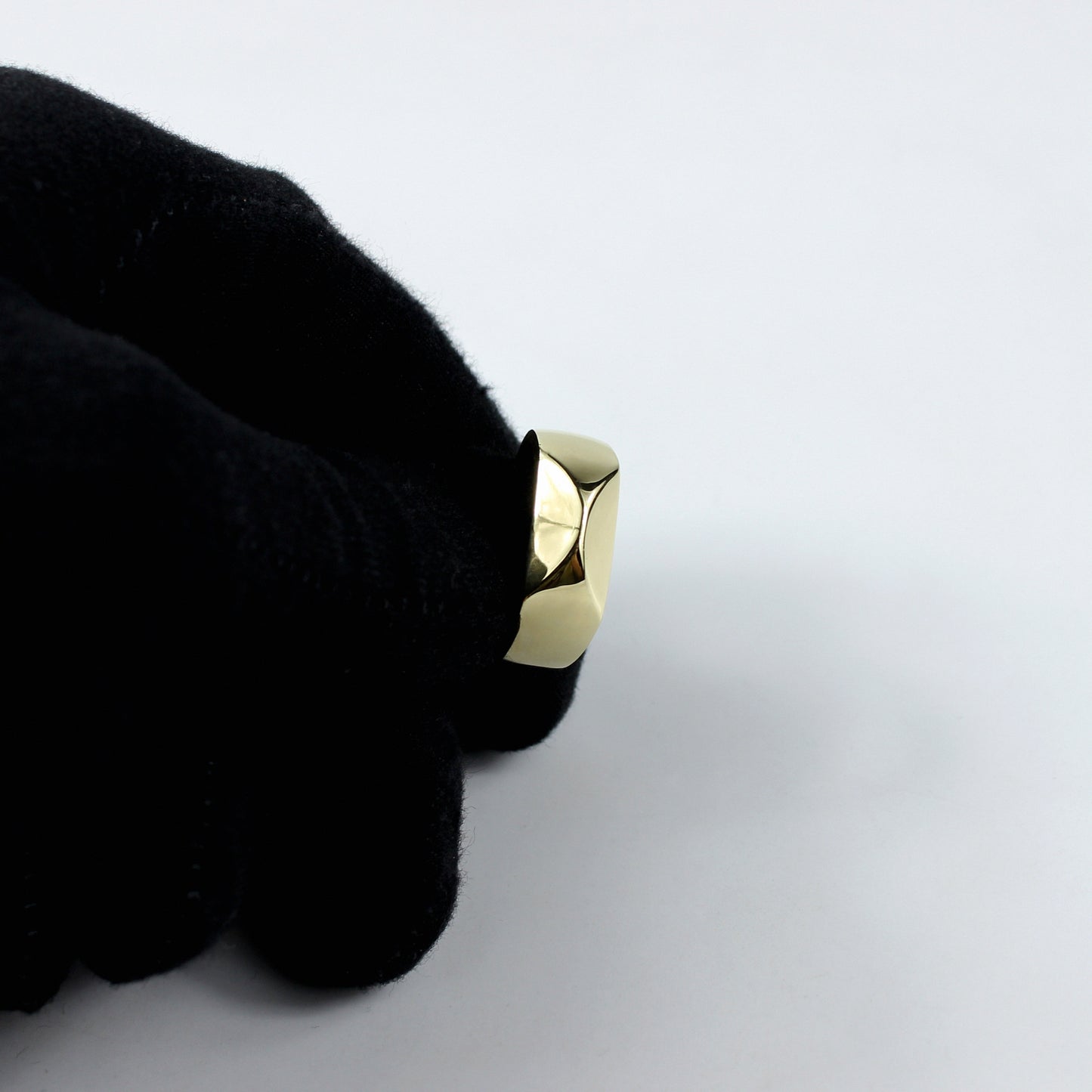 A refined ring crafted from brass and plated with 18k gold, showcasing a unique grip-inspired design. This modern and luxurious piece adds a touch of bold elegance, perfect for making a stylish statement.