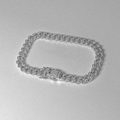 Iced Out Cuban Link Bracelet - A luxurious 925 sterling silver bracelet by GetTheJuice, featuring sparkling stones embedded in a robust Cuban link design that exudes elegance and glamour.