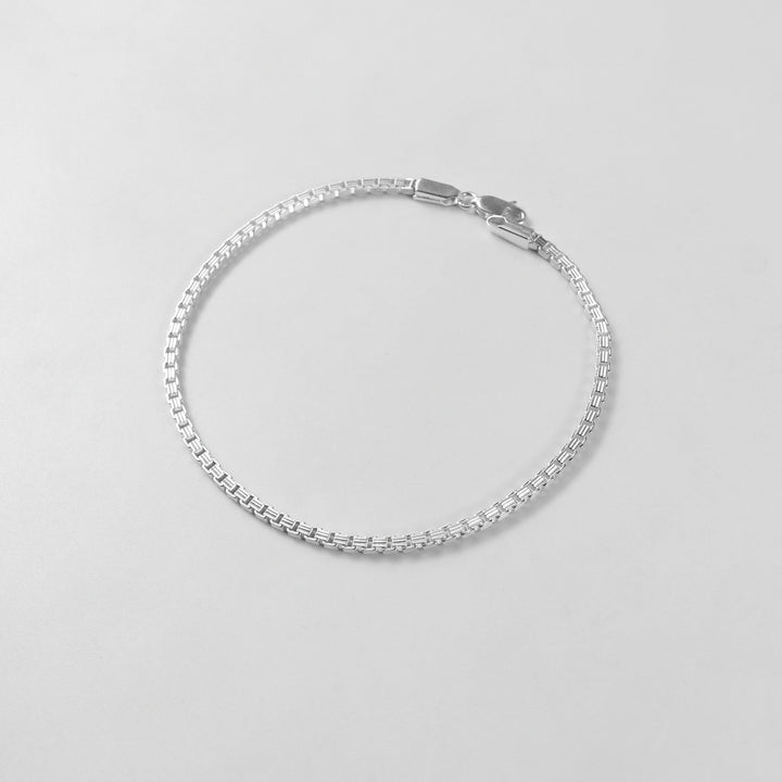 The 'Silken Glide' bracelet, crafted from 925 sterling silver, featuring a smooth and fluid design that embodies effortless grace.