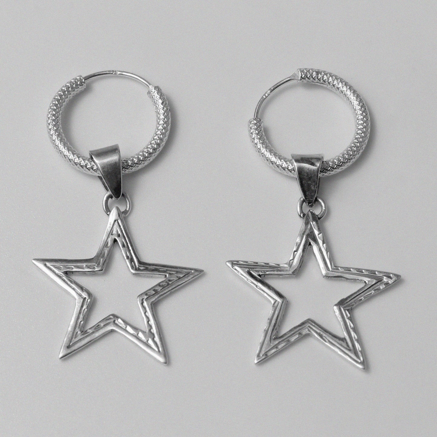 Starlight Earrings - An exquisite pair of 925 sterling silver earrings by GetTheJuice, with a captivating star design that captures the beauty of the night sky, making them a brilliant addition to any jewelry collection.