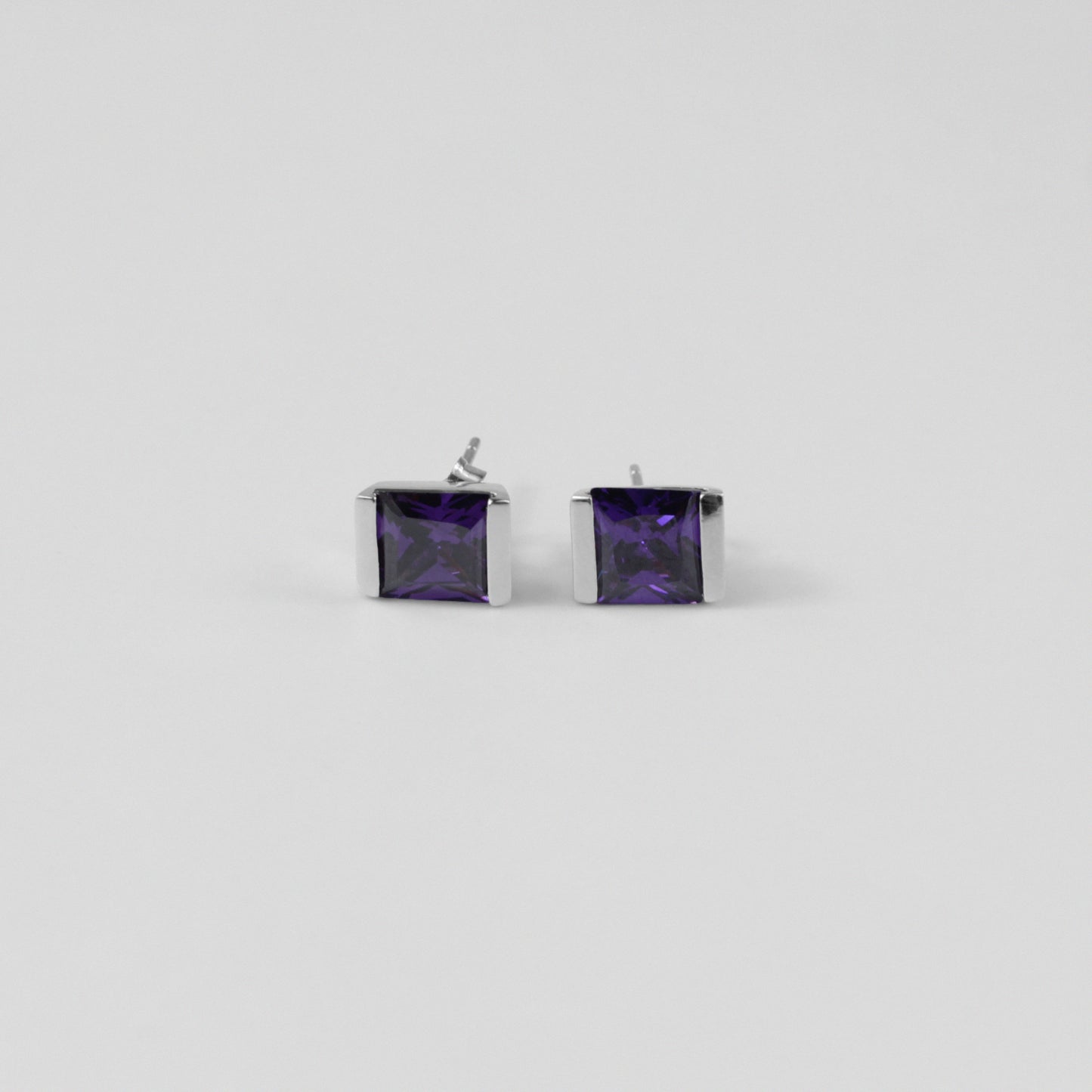 Violet Gleam Ear Studs - A stunning pair of 925 sterling silver ear studs by GetTheJuice, showcasing a sparkling violet hue that enhances any ensemble with a pop of vibrant elegance.