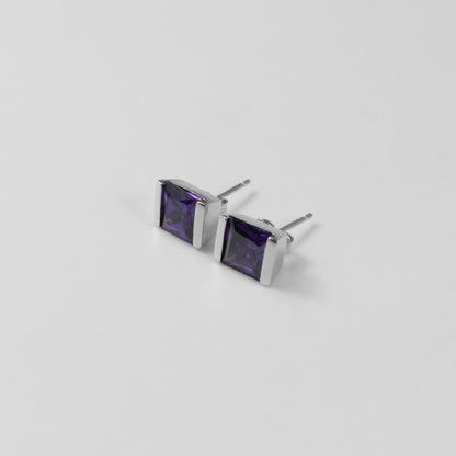 Violet Gleam Ear Studs - A stunning pair of 925 sterling silver ear studs by GetTheJuice, showcasing a sparkling violet hue that enhances any ensemble with a pop of vibrant elegance.