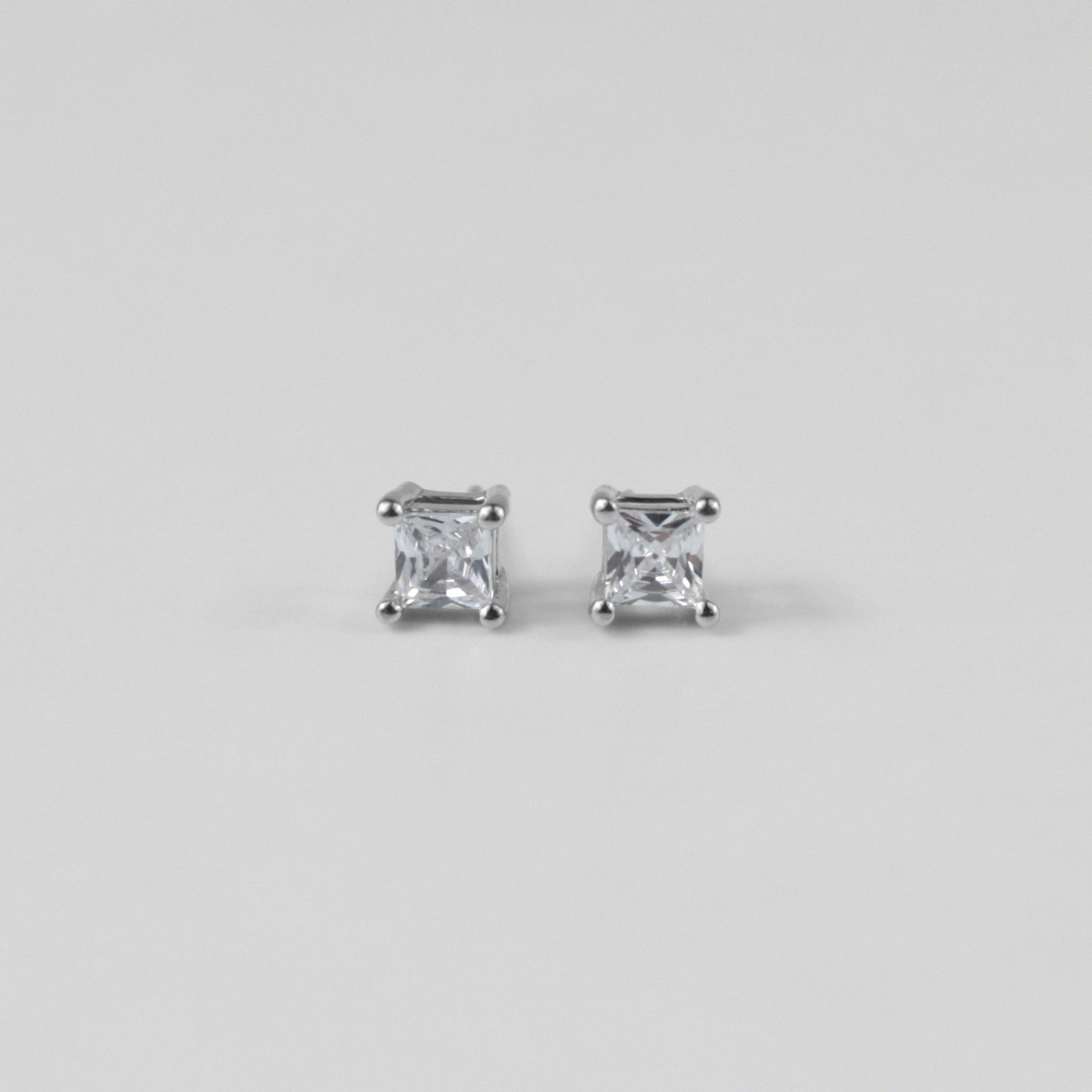 Whimsical White Ear Studs - A stunning pair of 925 sterling silver ear studs by GetTheJuice, showcasing a playful white motif that enhances any ensemble with a hint of lighthearted elegance.