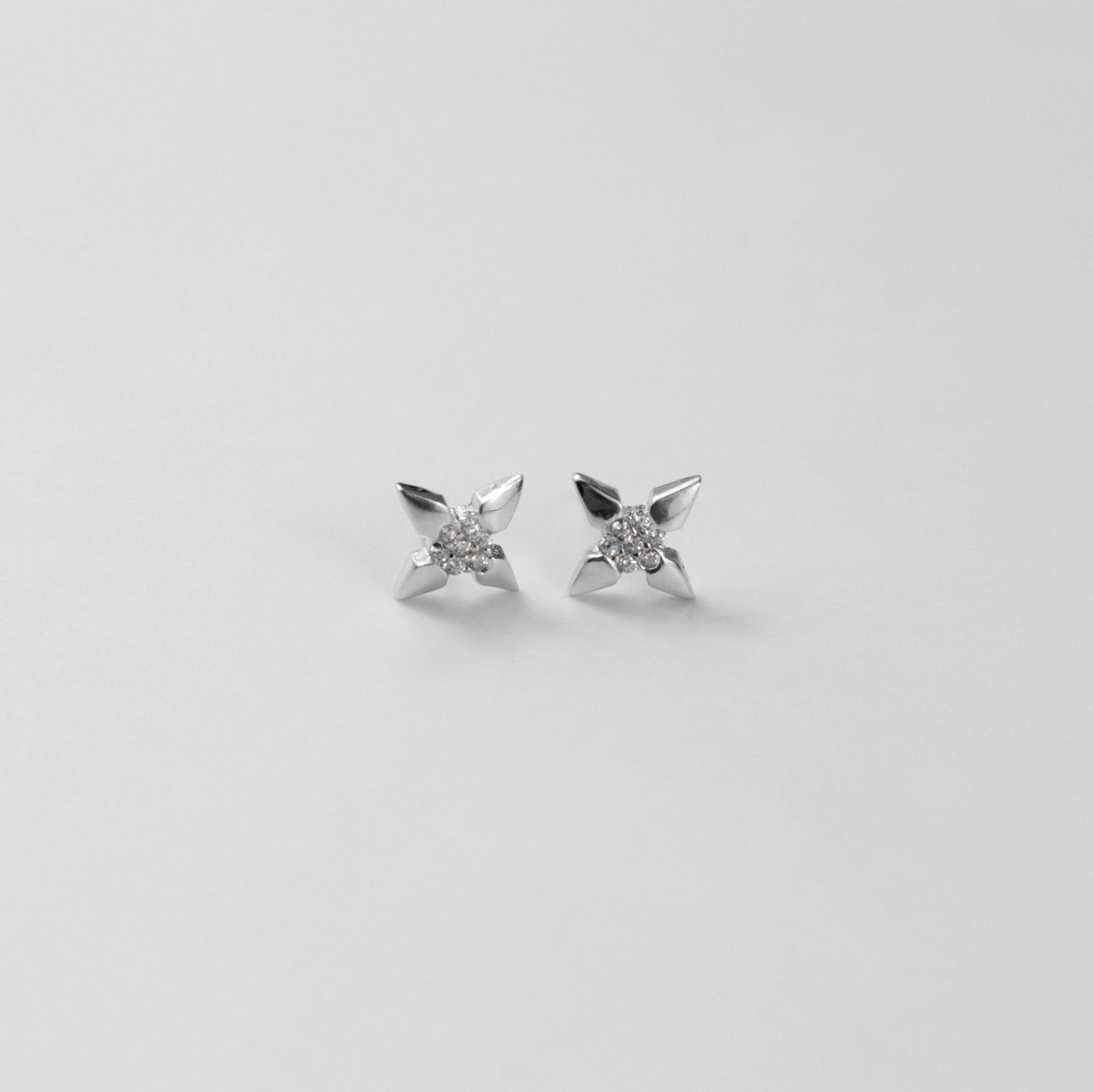 White Star Ear Studs - A stunning pair of 925 sterling silver ear studs by GetTheJuice, showcasing a dazzling white star motif, perfect for adding a sparkle of cosmic elegance to your ensemble.