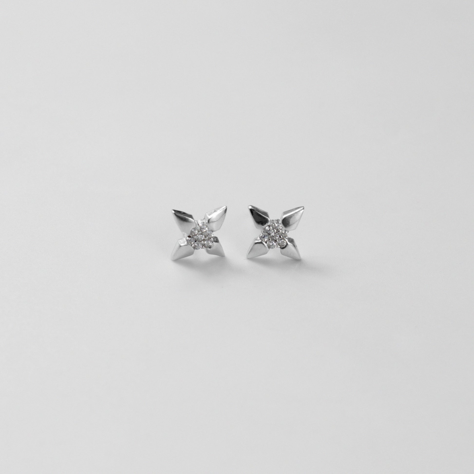 White Star Ear Studs - A stunning pair of 925 sterling silver ear studs by GetTheJuice, showcasing a dazzling white star motif, perfect for adding a sparkle of cosmic elegance to your ensemble.