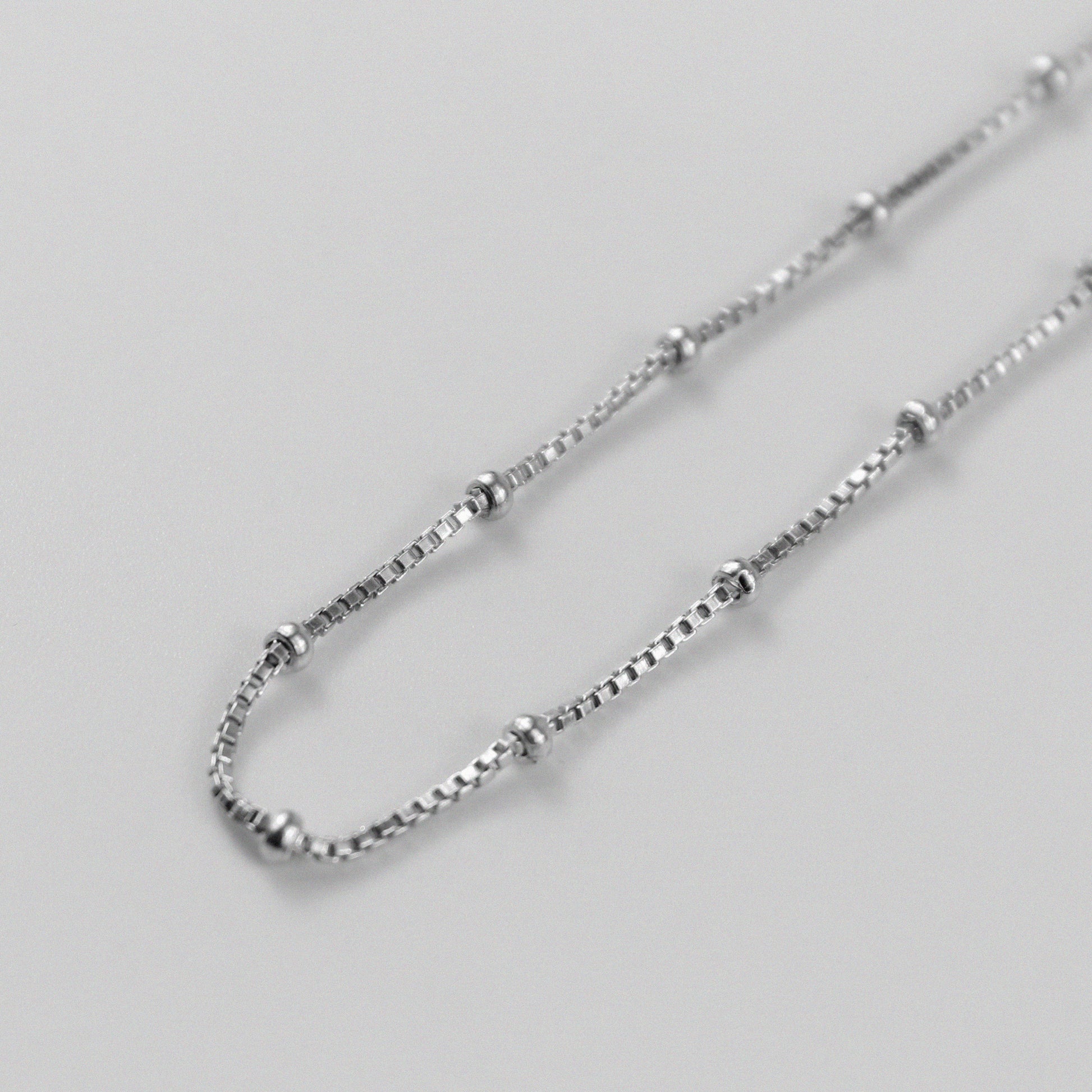 Rice Bead Satellite Necklace - An exquisite 925 sterling silver necklace by GetTheJuice, featuring delicate rice bead stations that add an elegant and contemporary flair to any ensemble.