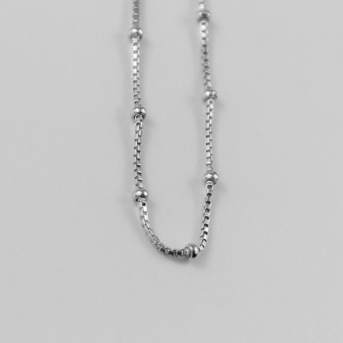 Rice Bead Satellite Necklace - An exquisite 925 sterling silver necklace by GetTheJuice, featuring delicate rice bead stations that add an elegant and contemporary flair to any ensemble.