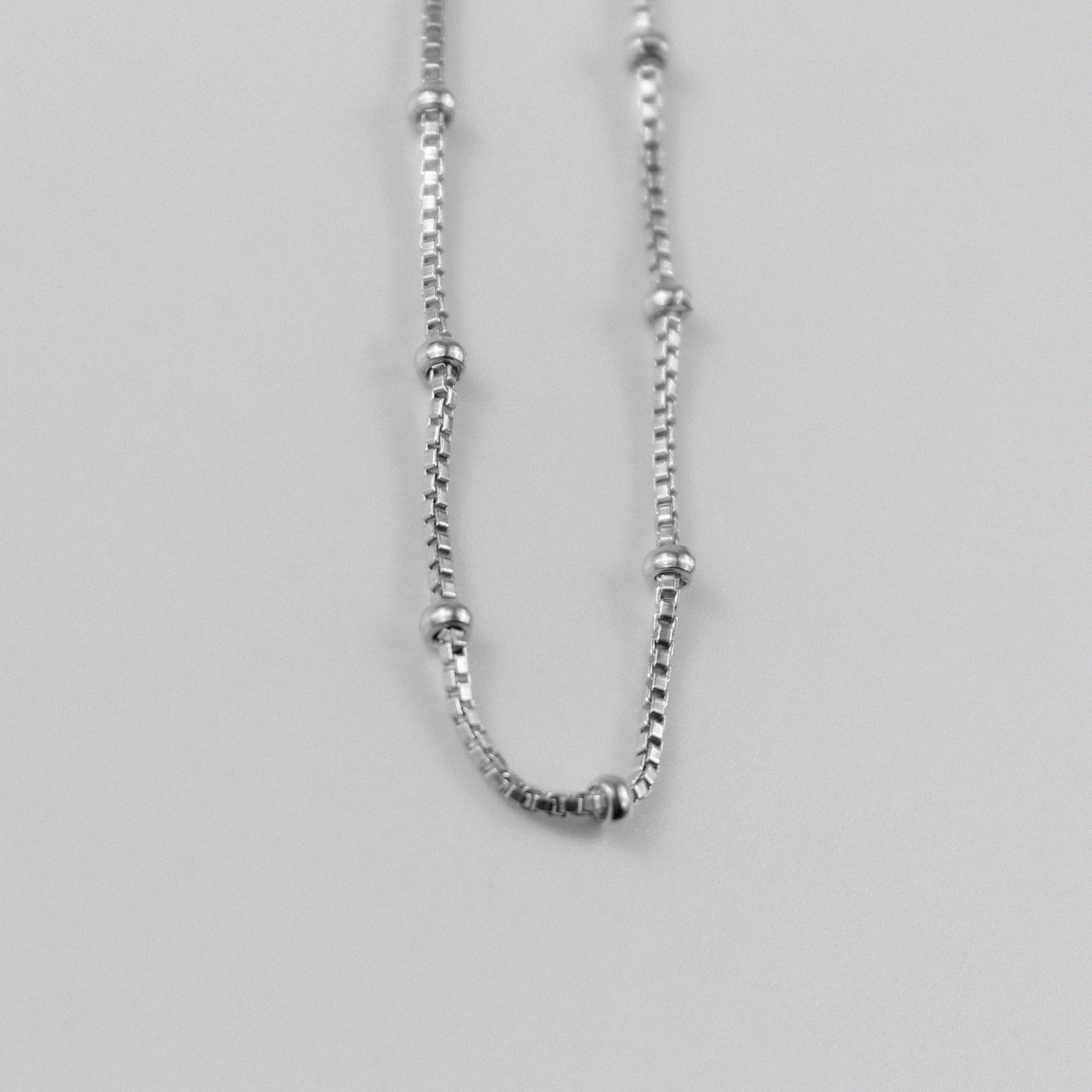 Rice Bead Satellite Necklace - An exquisite 925 sterling silver necklace by GetTheJuice, featuring delicate rice bead stations that add an elegant and contemporary flair to any ensemble.