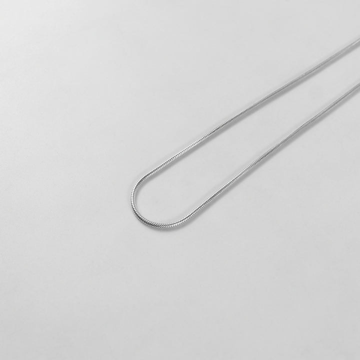 Round Snake Necklace - A refined 925 sterling silver necklace by GetTheJuice, showcasing a smooth and seamless round snake chain design that enhances any outfit with modern sophistication.