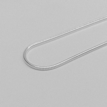 Round Snake Necklace - A refined 925 sterling silver necklace by GetTheJuice, showcasing a smooth and seamless round snake chain design that enhances any outfit with modern sophistication.