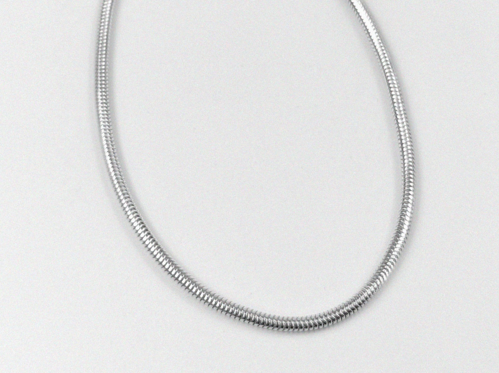 Round Snake Necklace - A refined 925 sterling silver necklace by GetTheJuice, showcasing a smooth and seamless round snake chain design that enhances any outfit with modern sophistication.