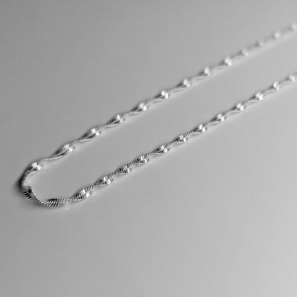 Twisted Lotus Necklace - An elegant 925 sterling silver necklace by GetTheJuice, showcasing a unique twisted lotus motif that adds a touch of sophistication to any look.