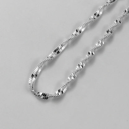 Twisted Lotus Necklace - An elegant 925 sterling silver necklace by GetTheJuice, showcasing a unique twisted lotus motif that adds a touch of sophistication to any look.