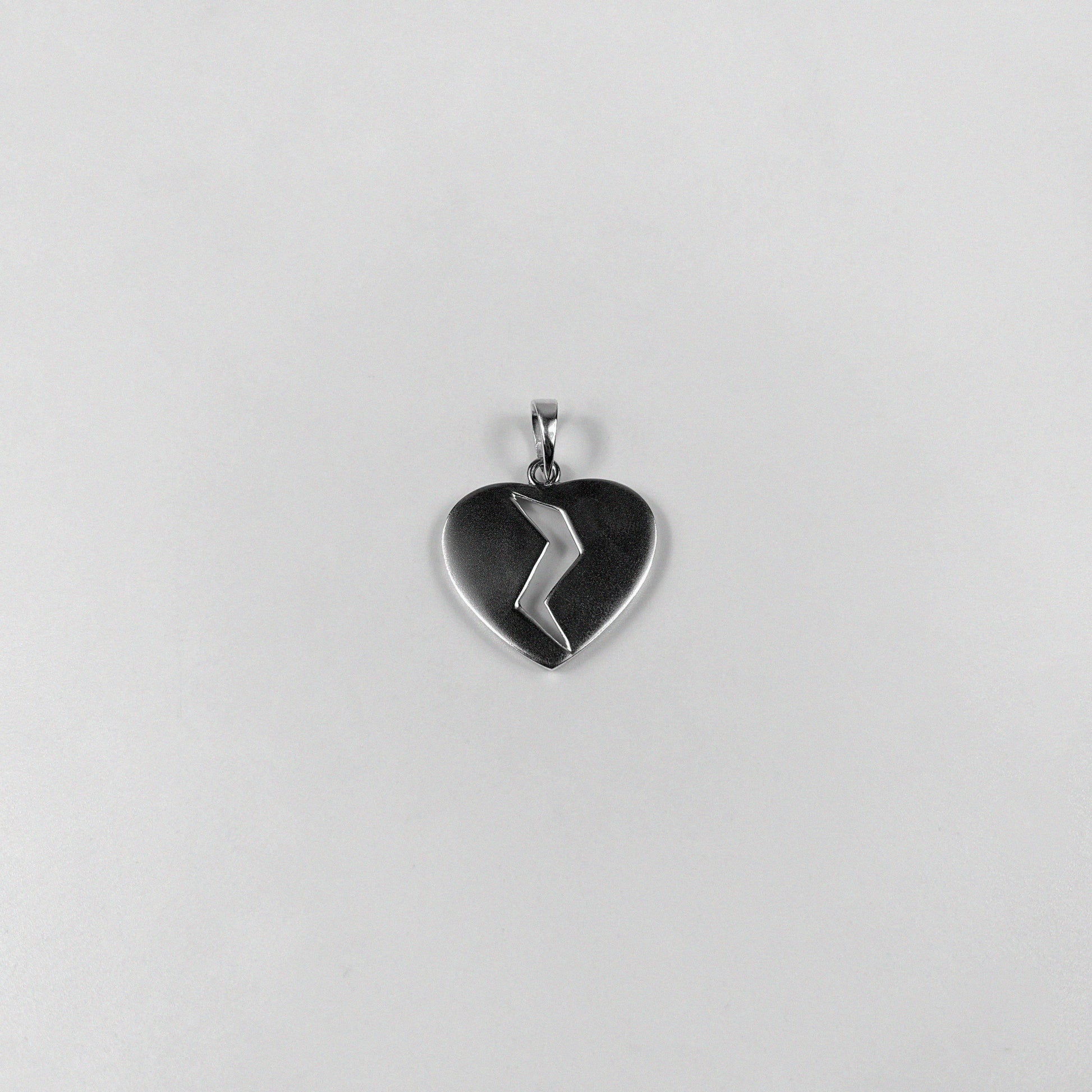 Broken Heart Pendant - A beautifully crafted 925 sterling silver pendant by GetTheJuice, featuring a poignant broken heart design that adds a touch of emotional elegance and charm to any look.