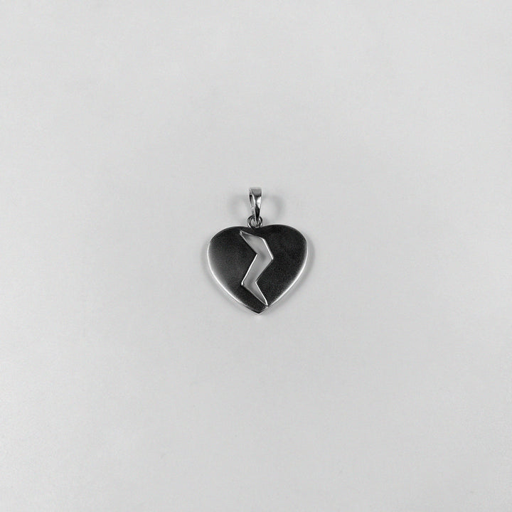 Broken Heart Pendant - A beautifully crafted 925 sterling silver pendant by GetTheJuice, featuring a poignant broken heart design that adds a touch of emotional elegance and charm to any look.