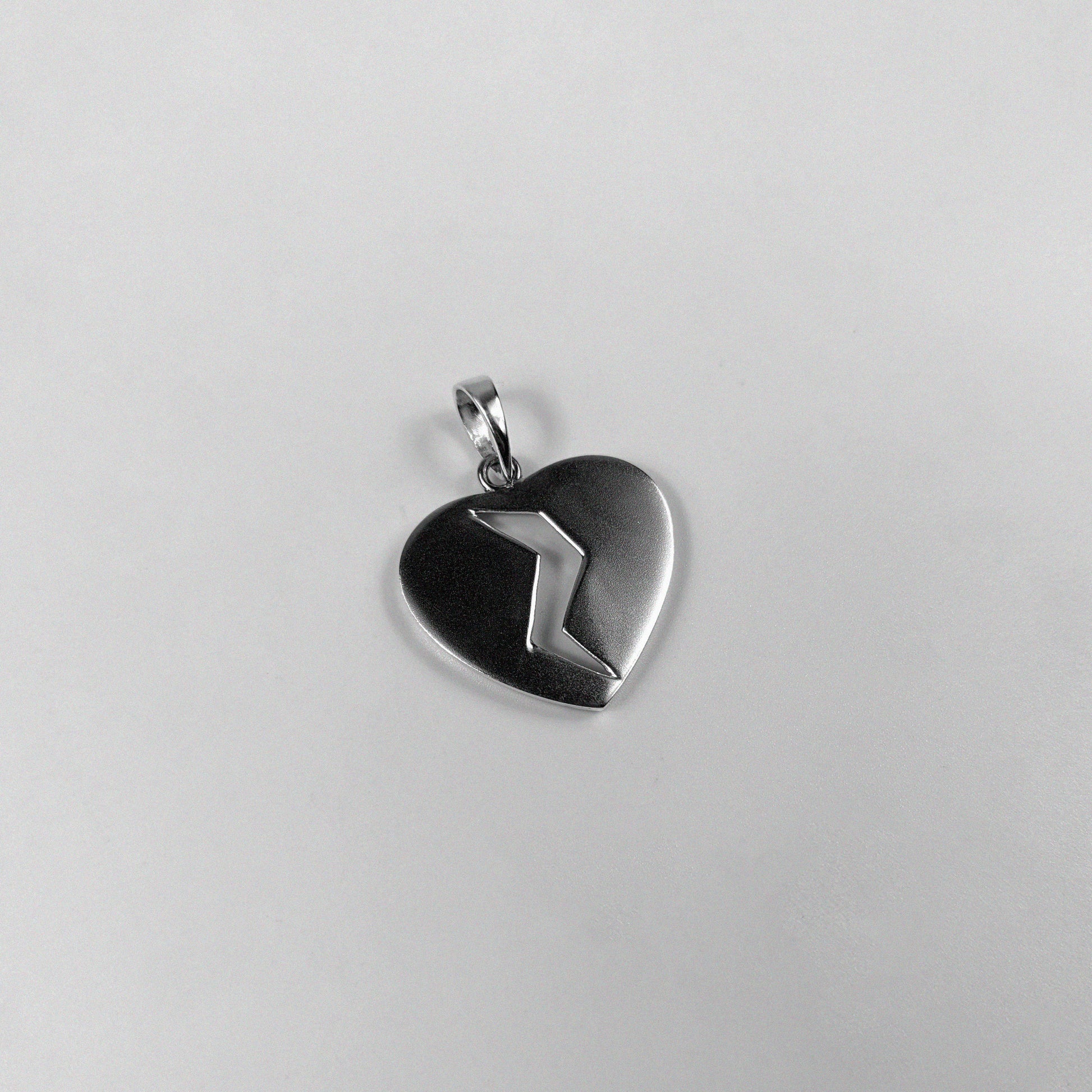 Broken Heart Pendant - A beautifully crafted 925 sterling silver pendant by GetTheJuice, featuring a poignant broken heart design that adds a touch of emotional elegance and charm to any look.