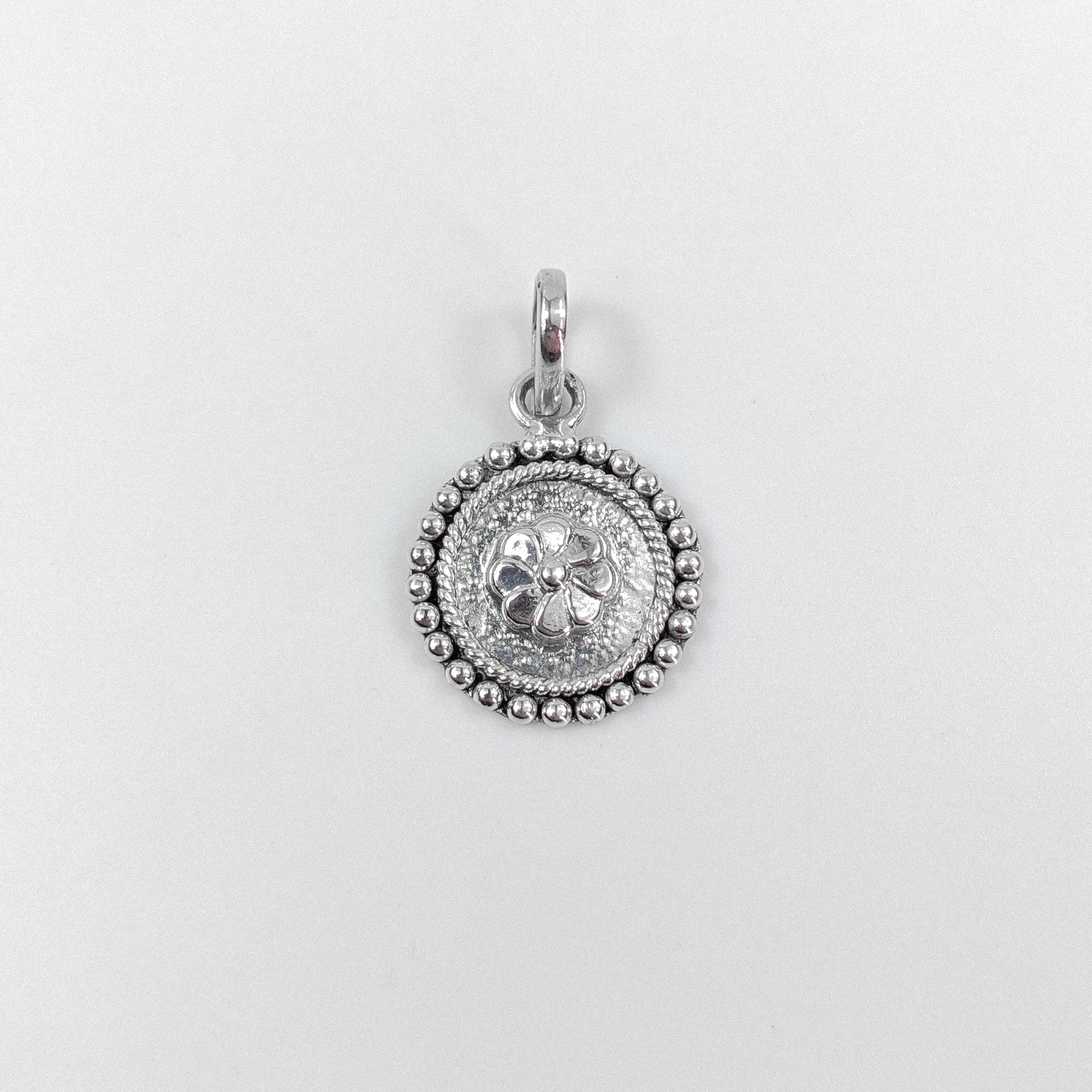 Floral Wheel Pendant - An elegant 925 sterling silver pendant by GetTheJuice, featuring a beautifully crafted floral wheel design that adds a touch of natural grace and charm to any look.