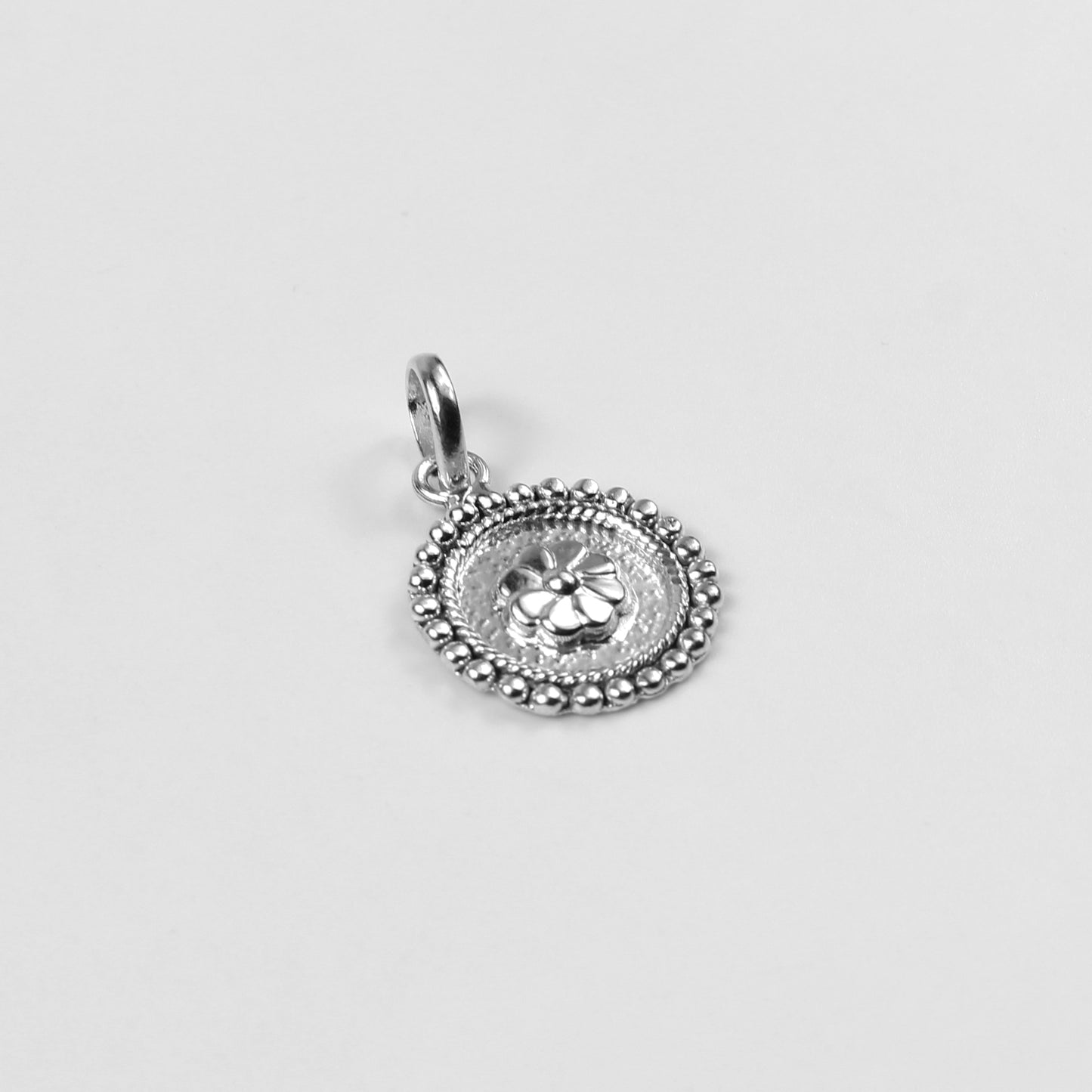 Floral Wheel Pendant - An elegant 925 sterling silver pendant by GetTheJuice, featuring a beautifully crafted floral wheel design that adds a touch of natural grace and charm to any look.