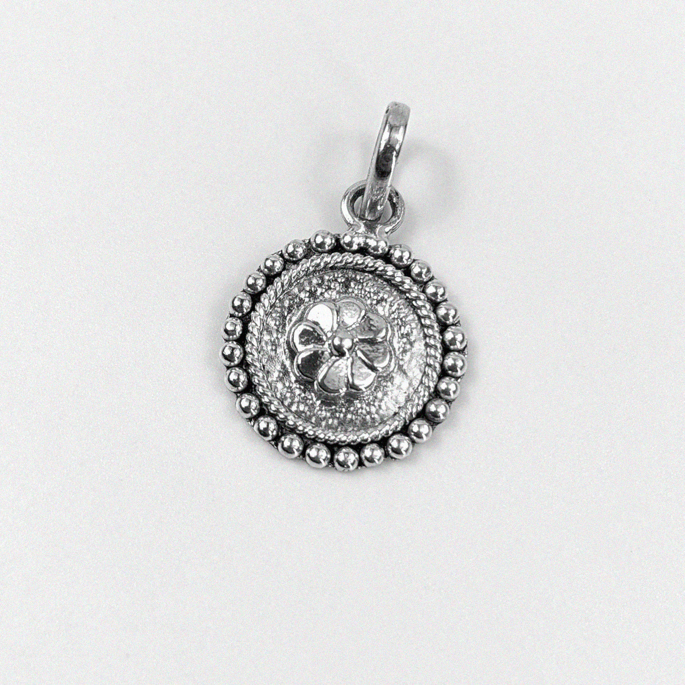 Floral Wheel Pendant - An elegant 925 sterling silver pendant by GetTheJuice, featuring a beautifully crafted floral wheel design that adds a touch of natural grace and charm to any look.