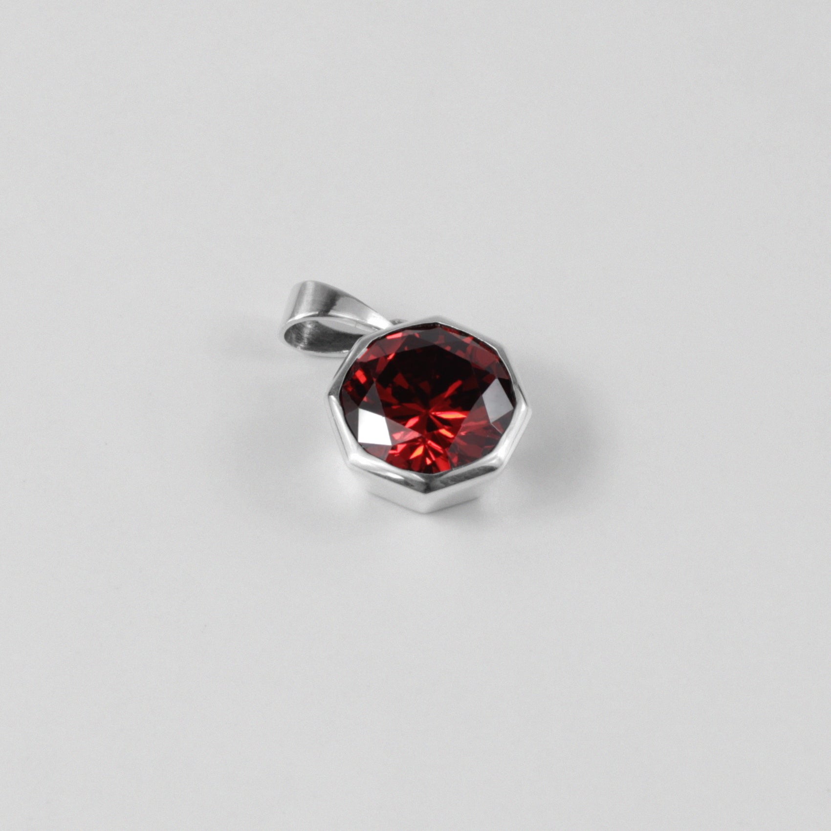 Round Red Pendant - A stunning 925 sterling silver pendant by GetTheJuice, showcasing a radiant red stone in a refined circular setting, perfect for adding a bold splash of color and charm to any outfit.