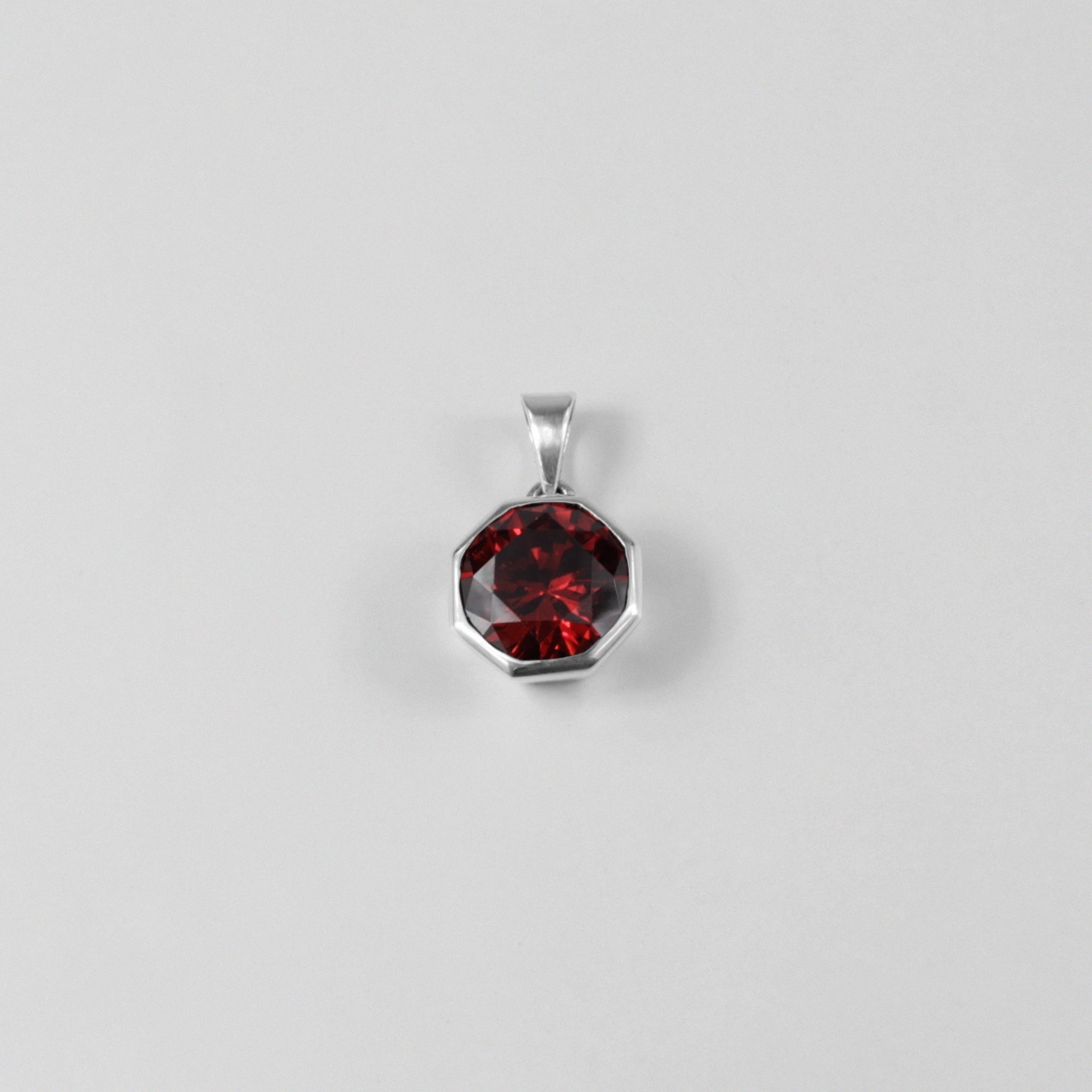 Round Red Pendant - A stunning 925 sterling silver pendant by GetTheJuice, showcasing a radiant red stone in a refined circular setting, perfect for adding a bold splash of color and charm to any outfit.