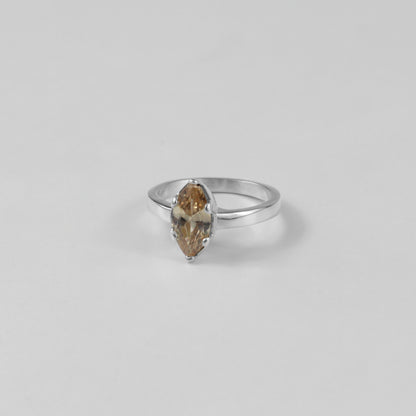 Sterling silver ring stamped '925,' featuring a glowing amber-colored gemstone centerpiece.