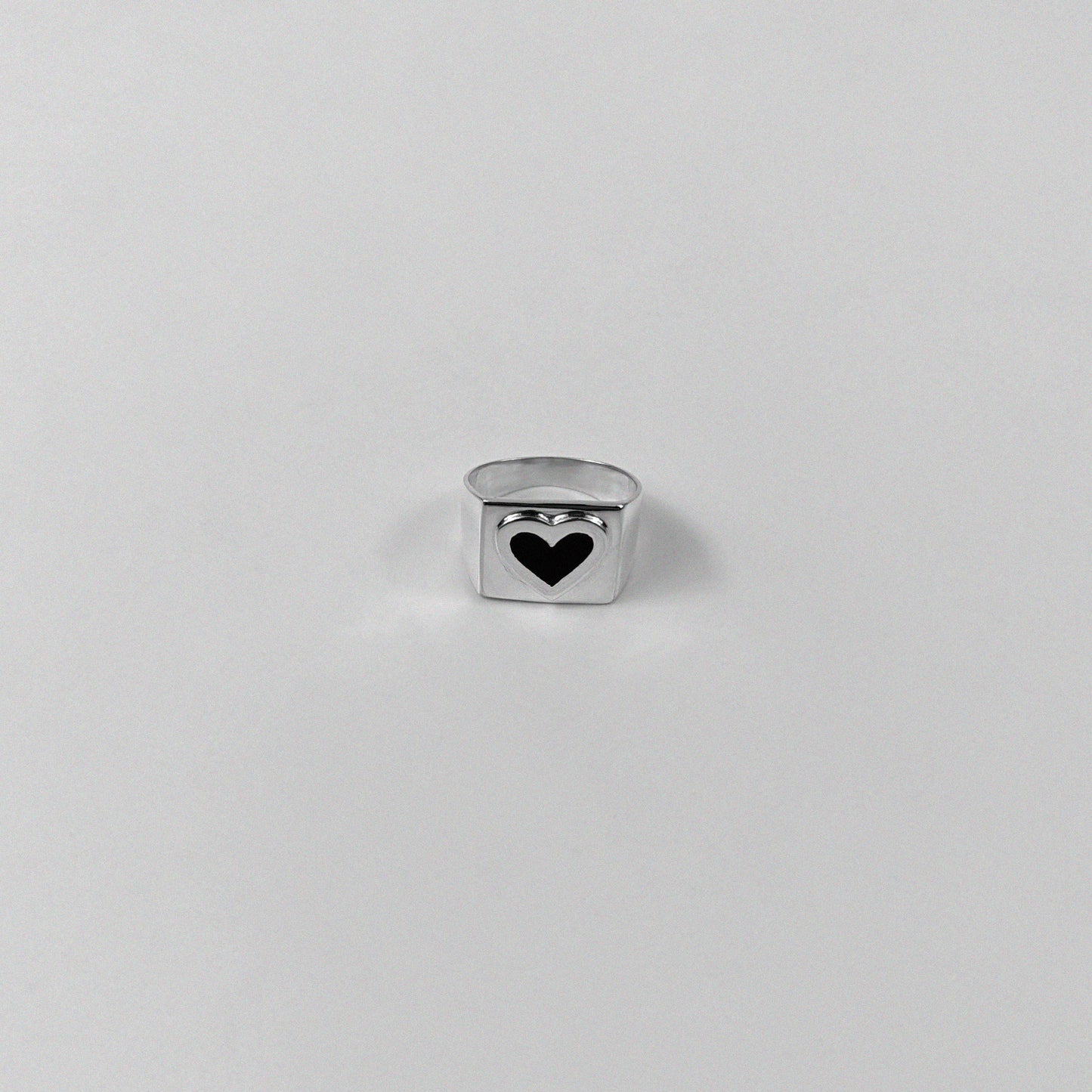 Sterling silver ring stamped '925,' showcasing a bold black heart-shaped design.