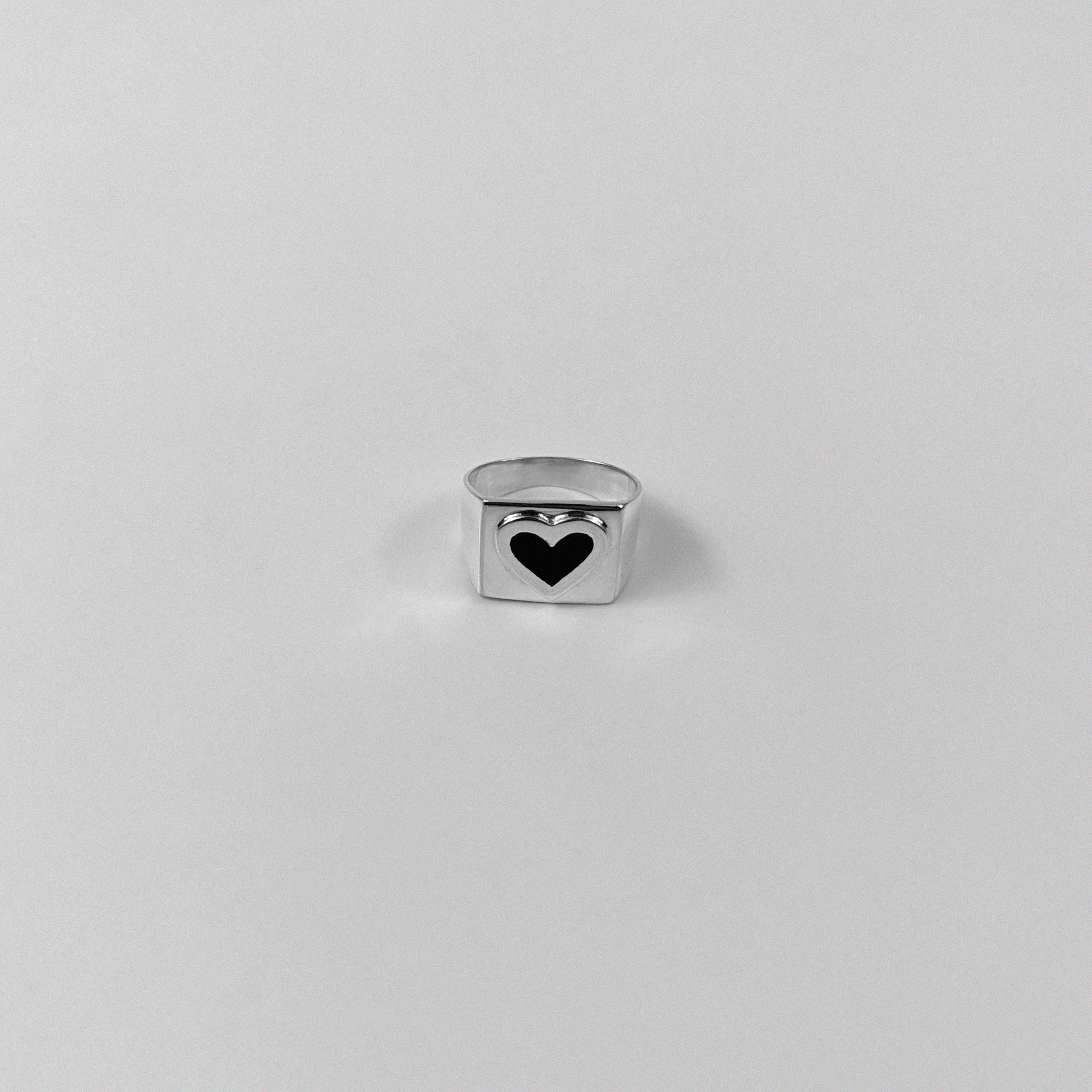 Sterling silver ring stamped '925,' showcasing a bold black heart-shaped design.