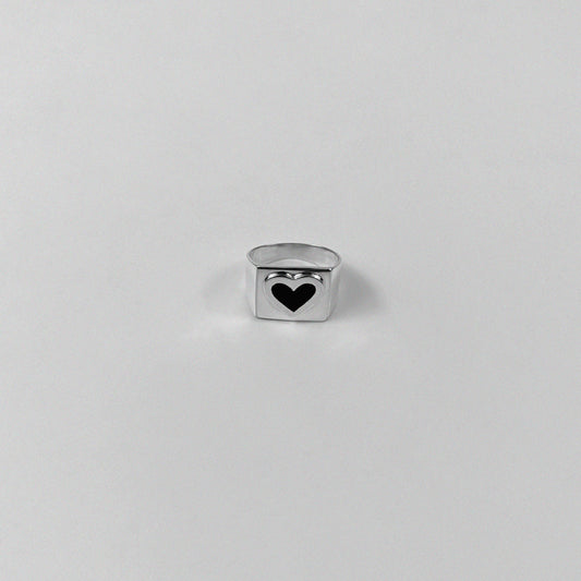 Sterling silver ring stamped '925,' showcasing a bold black heart-shaped design.