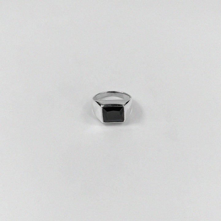 Sterling silver ring stamped '925,' featuring a bold black stone centerpiece.