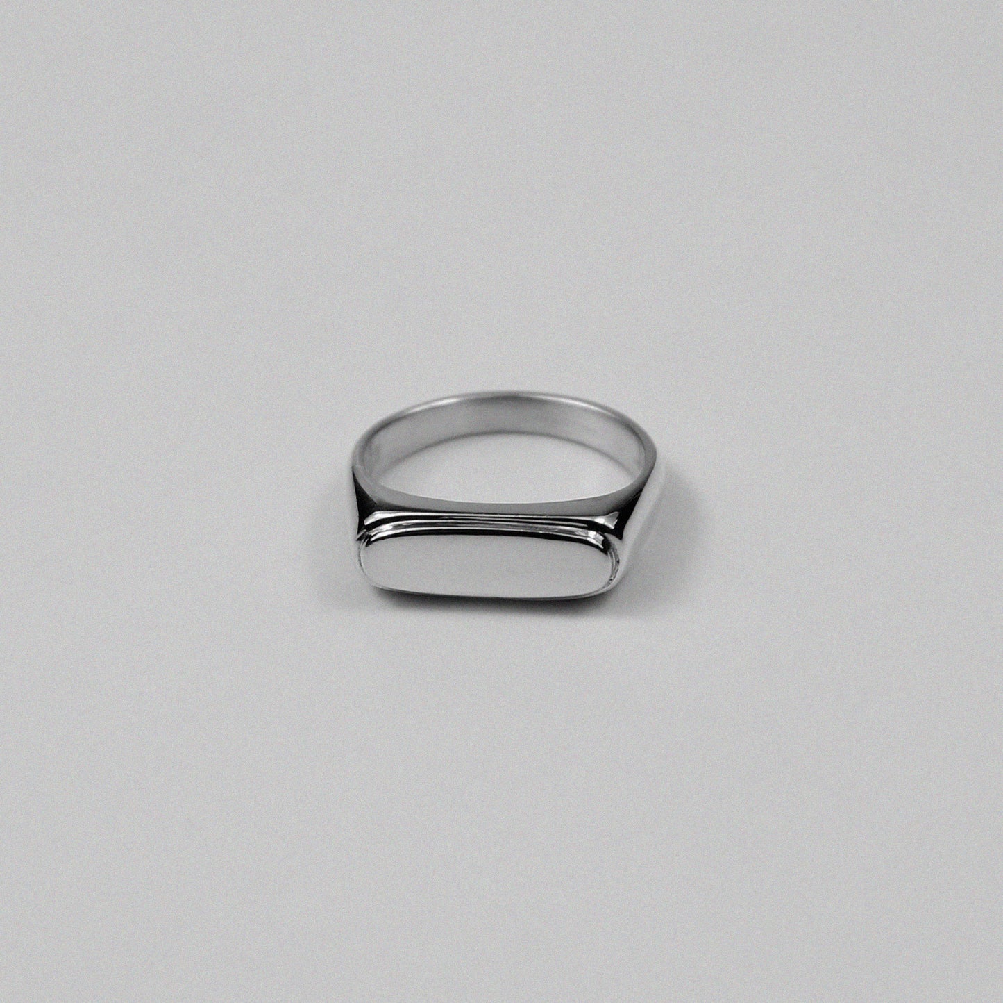 Sterling silver signet ring stamped '925,' featuring a sleek and minimalist design, named 'Blink Signet Ring.