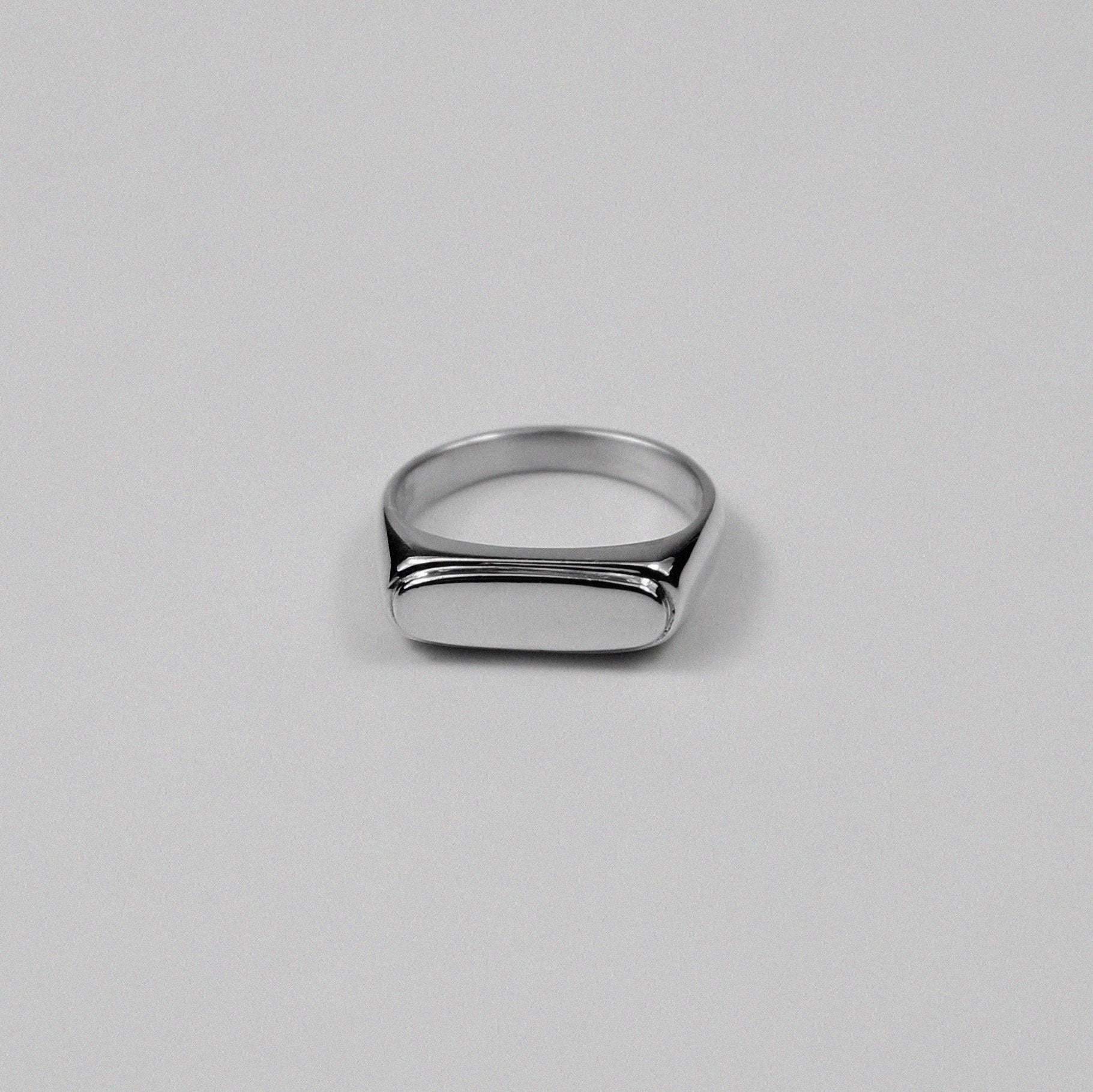 Sterling silver signet ring stamped '925,' featuring a sleek and minimalist design, named 'Blink Signet Ring.