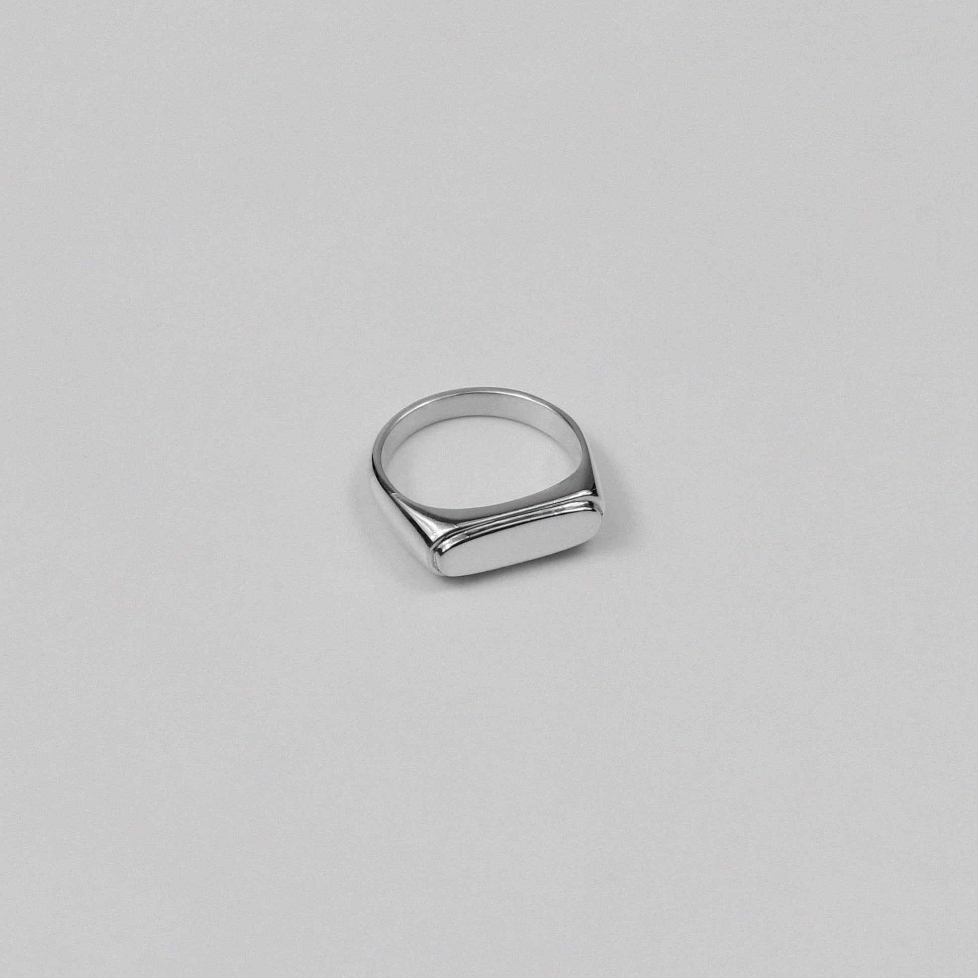 Sterling silver signet ring stamped '925,' featuring a sleek and minimalist design, named 'Blink Signet Ring.