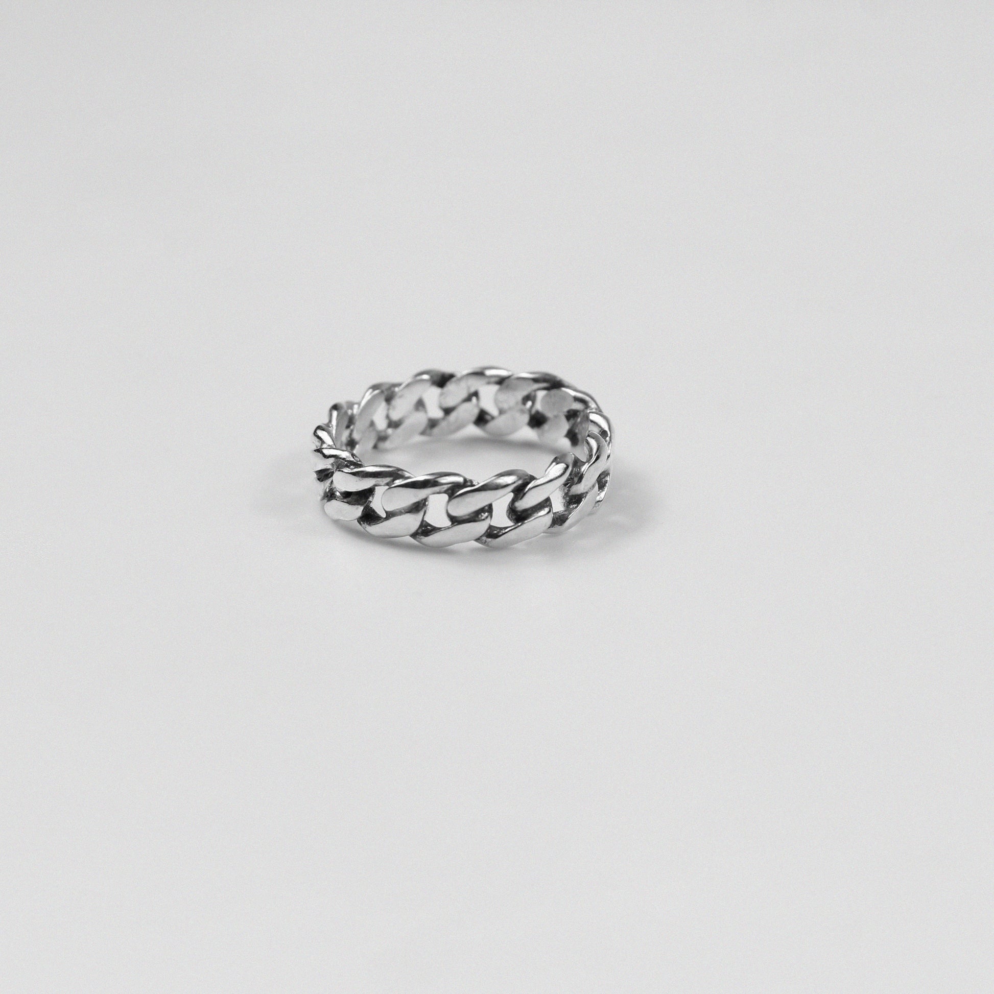 Sterling silver ring stamped '925,' featuring an intricate chain-inspired design, named 'ChainFusion Ring.