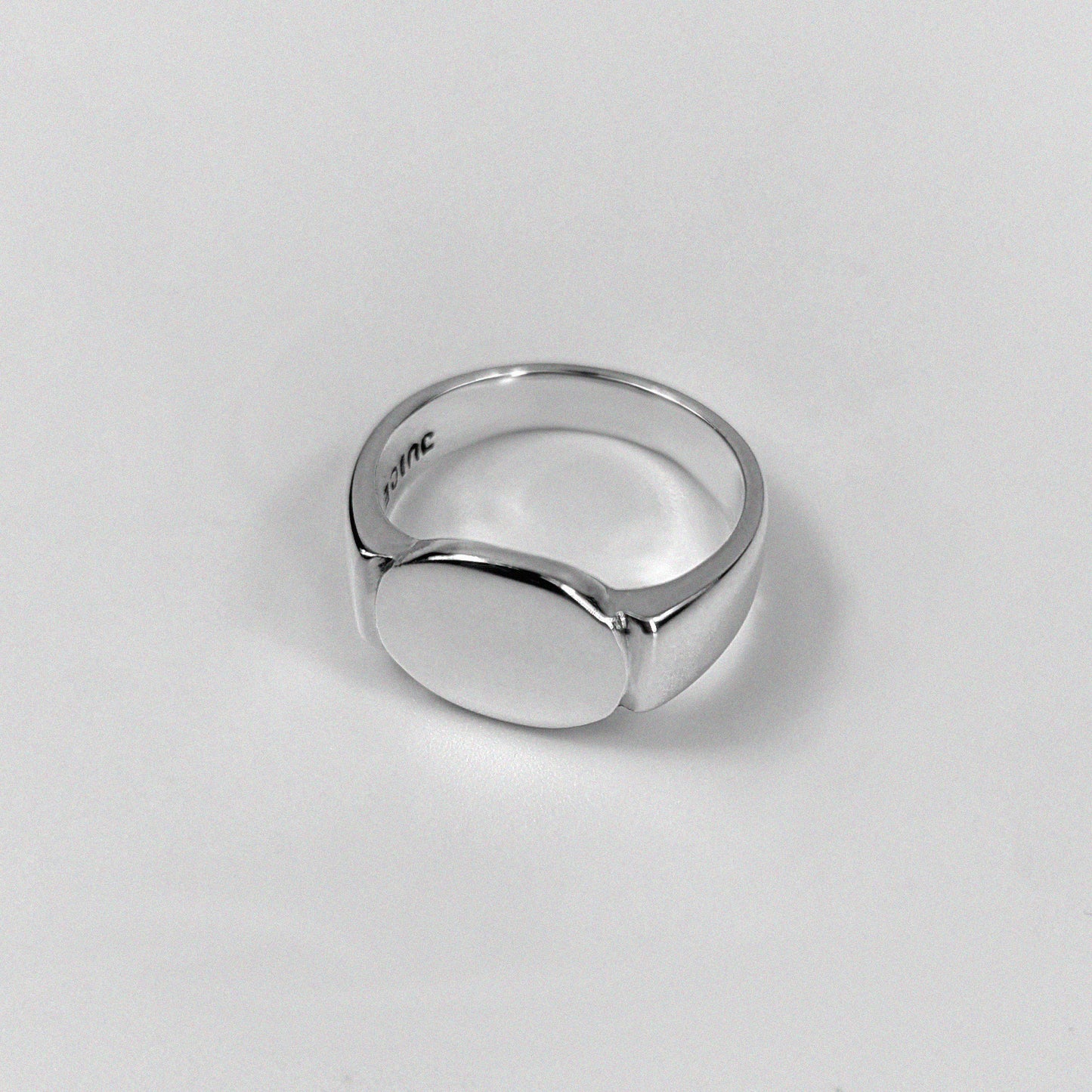 Sterling silver ring stamped '925,' featuring a sleek, circular design inspired by an eclipse, named 'Eclipse Ring.